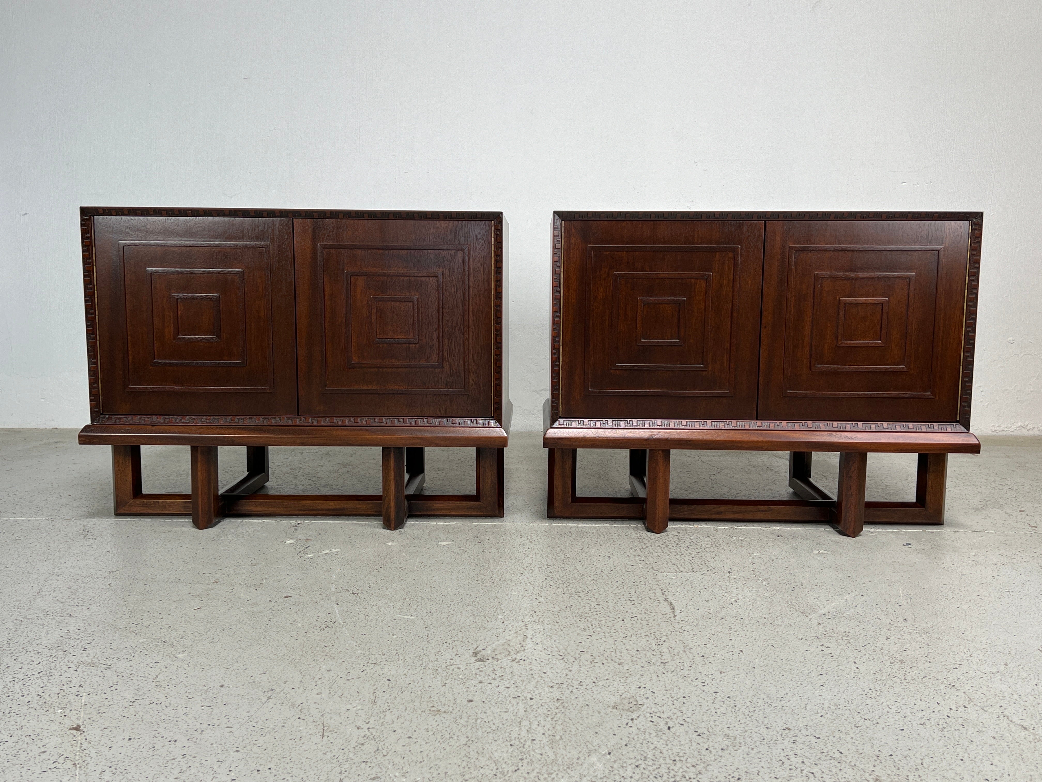 A rare pair of concentric square cabinets on stands designed by Frank Lloyd Wright for Henredon. Each cabinet opens to a single adjustable shelf. 