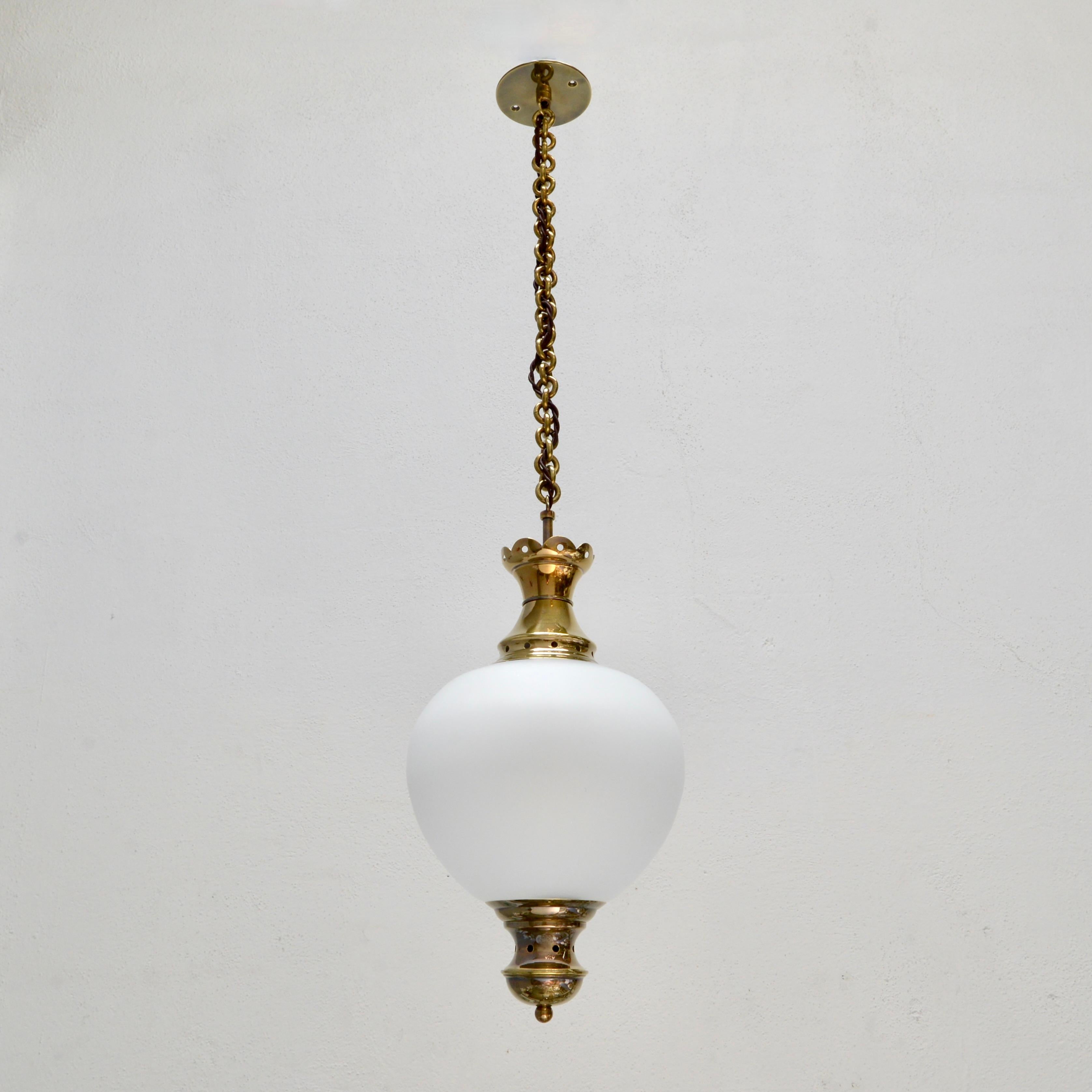 Elegant 1950s pair of pendants from Luigi Caccia Dominioni for Azucena of Italy. Naturally aged un-lacquered brass, restored, solid brass chain. Wired with 1-E26 medium based socket for use in the US. Light bulbs included with order.