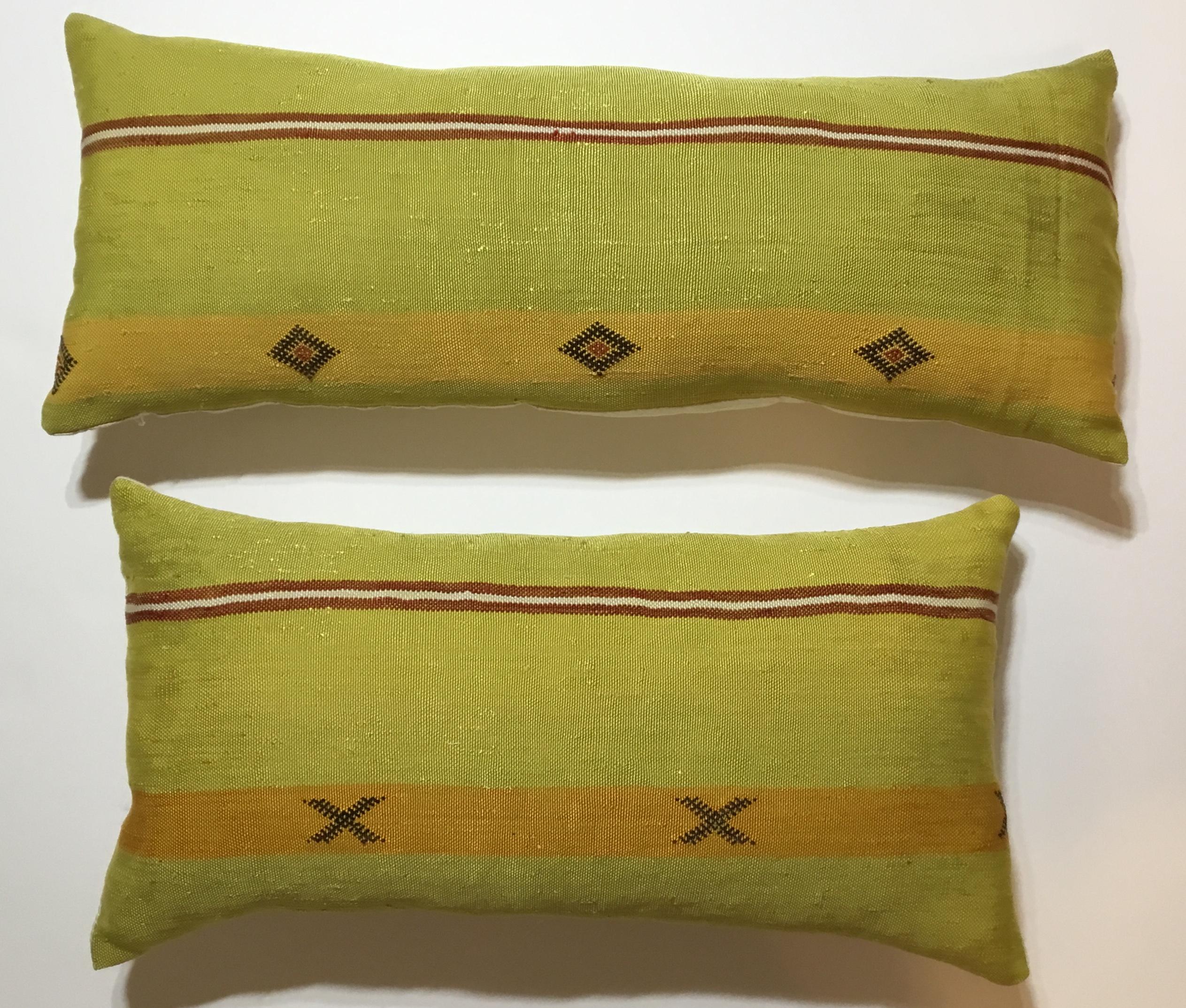 Beautiful pair of pillows made of handwoven flat-weave Kilim textile fragment ,with geometric motifs , unusual funky colors of black muster and lime, fine silk backing and fresh inserts.
Size:
23”.5 x 12”x 4”
27” x 11” x 4”.
  