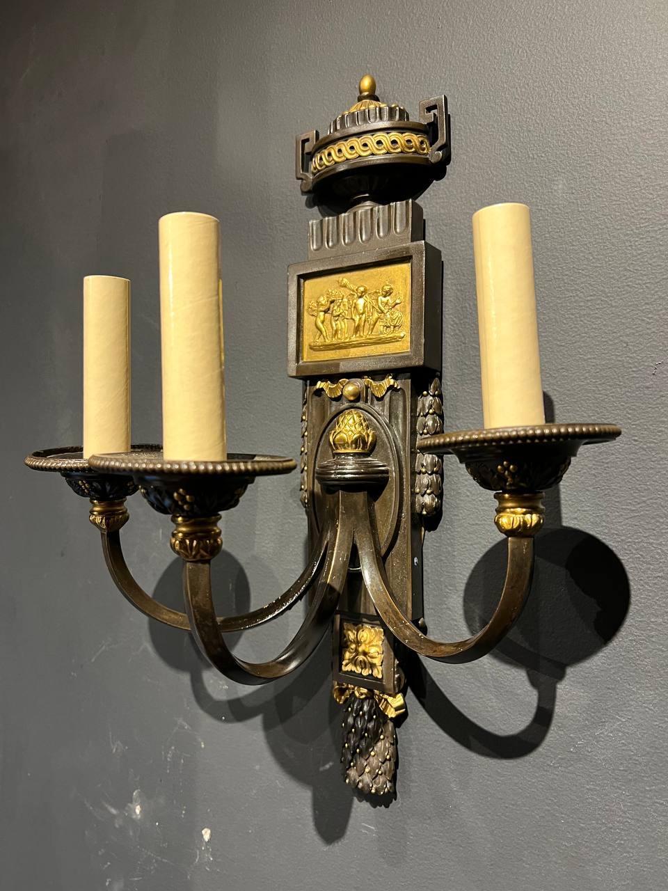 A pair of Caldwell sconces with neoclassical design with brown patinated finish and gilt metal, circa 1920s. In very good vintage condition.

Dealer: G302YP