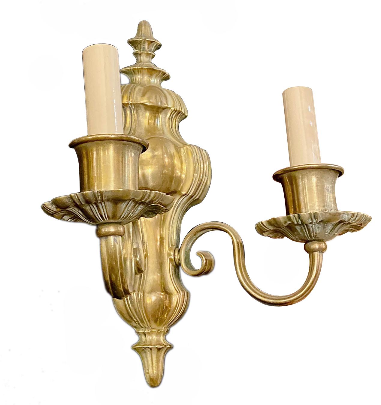 A pair of circa 1920s bronze Caldwell sconces in a neoclassic style.

Measurements:
Height 12