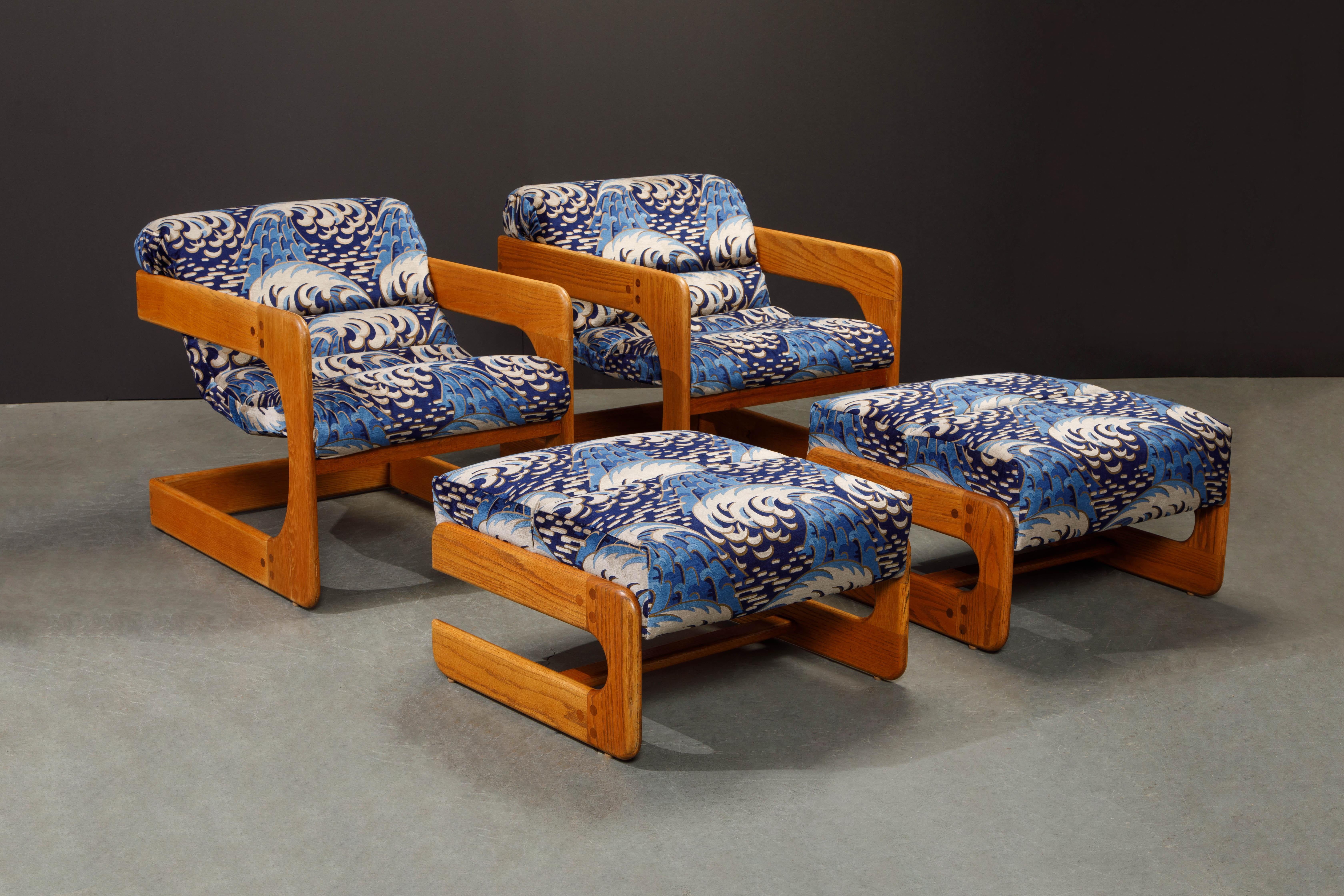 This incredible set of two lounge chairs and two ottomans by Lou Hodges for California Design Group just completed full restoration, beautifully refinished oak frames and newly reupholstered in a Lee Jofa velvet fabric. The set is signed with maker