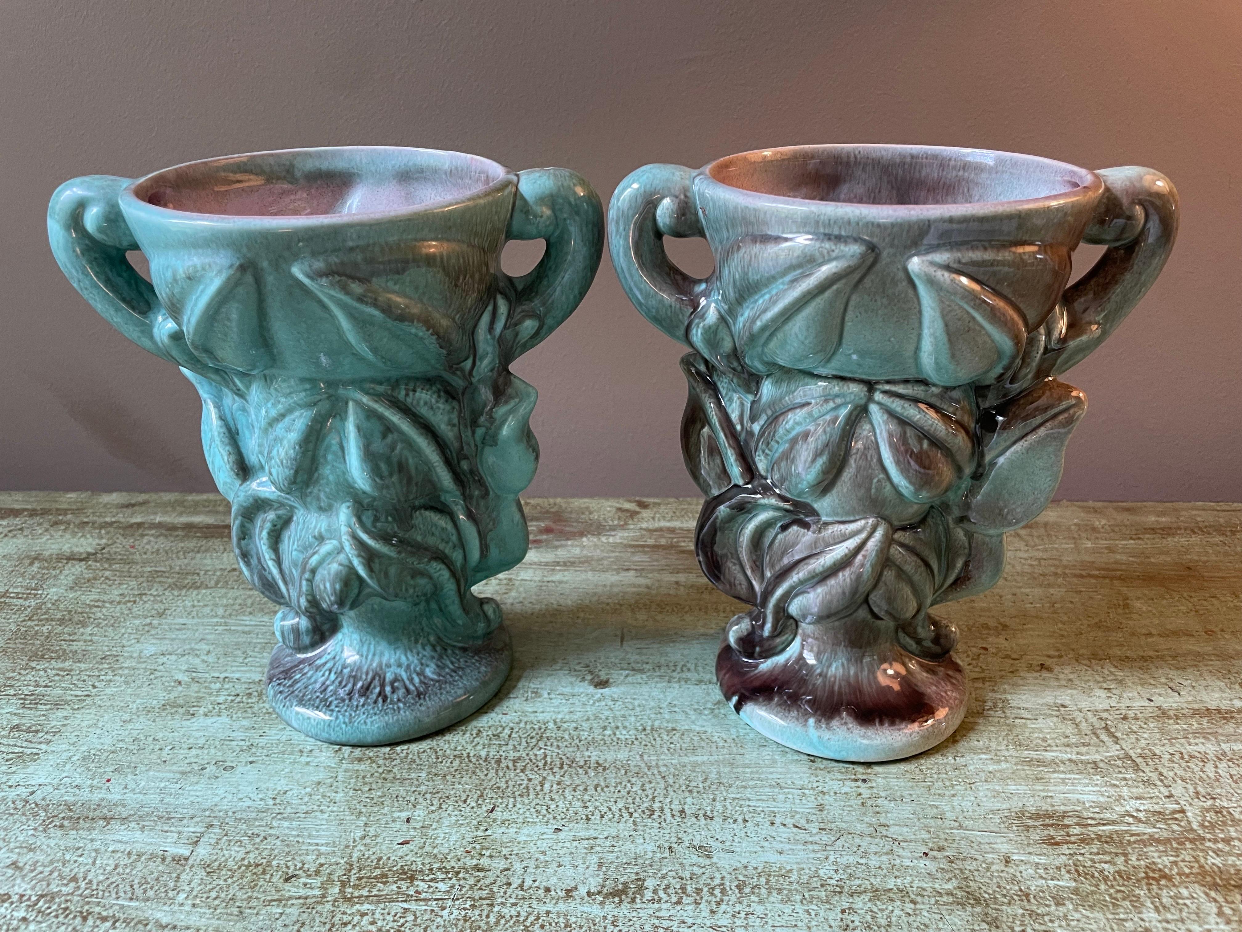 Attractive and unique, this wild vase pair will bring impact to any room! Great color and handwork are on display in this mid 20th century find - possibly a married pair? The greens flowing into interior pinks - who needs flowers in these beauties?.