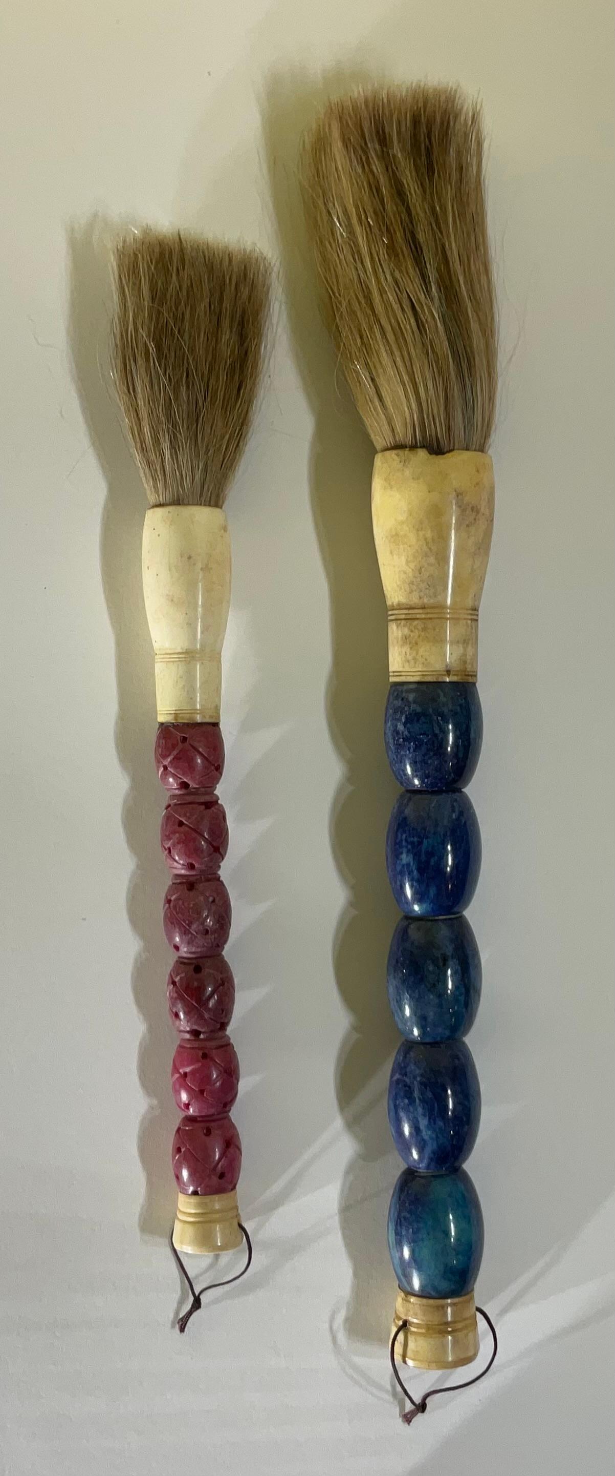 Beautiful pair of hand made calligraphy brushes with blue and wine colors marble beads ,bone , ferrule and horse hair. 
 Slight variation in each brush due to characteristics of genuine stone and bone.
Brash size :
1.  15” x 1,5
2. 12” x 1