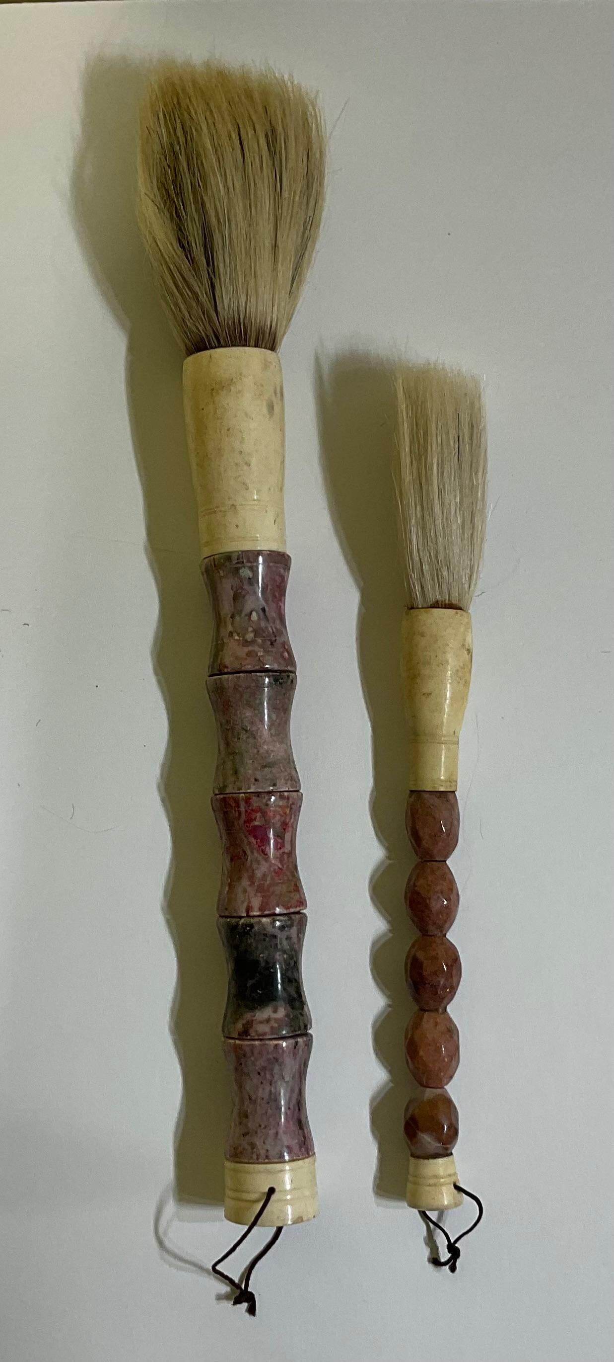 Beautiful pair of hand made calligraphy brushes with soft wine colors ,marble beads ,bone , ferrule and horse hair. 
 Slight variation in each brush due to characteristics of genuine stone and bone.
Brash size :
1.  15” x 1,25
2. 11” x 0.75