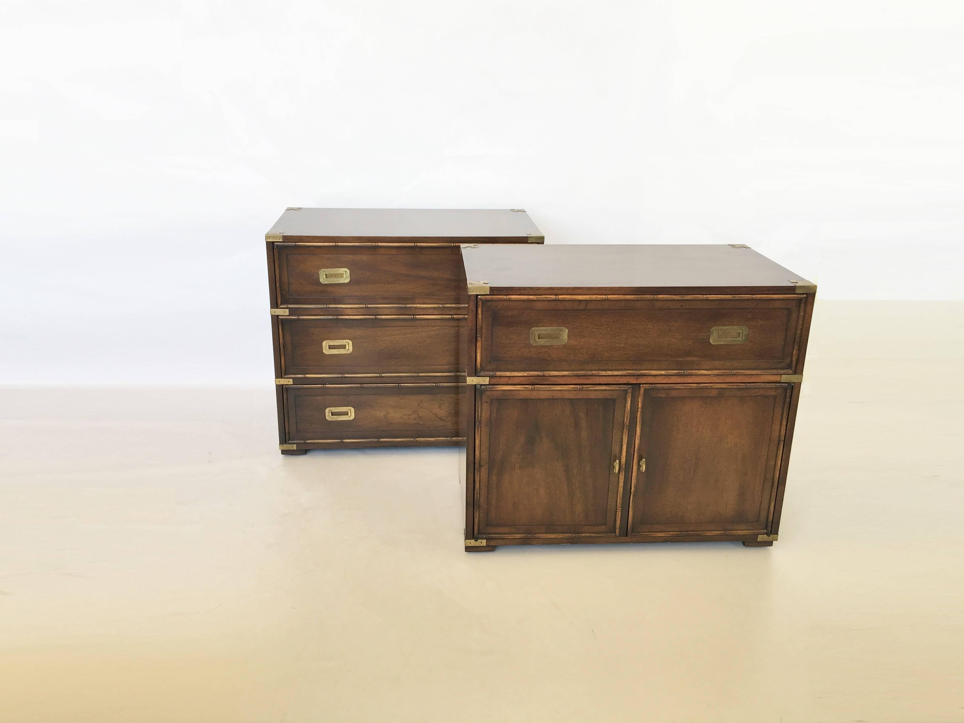 Classic Hollywood Regency pair of Campaign dressers manufactured by Hekman Furniture. Made of exceptional quality; everything is solid wood. One features three dovetailed drawers each with solid brass pulls and original finish. Other features a