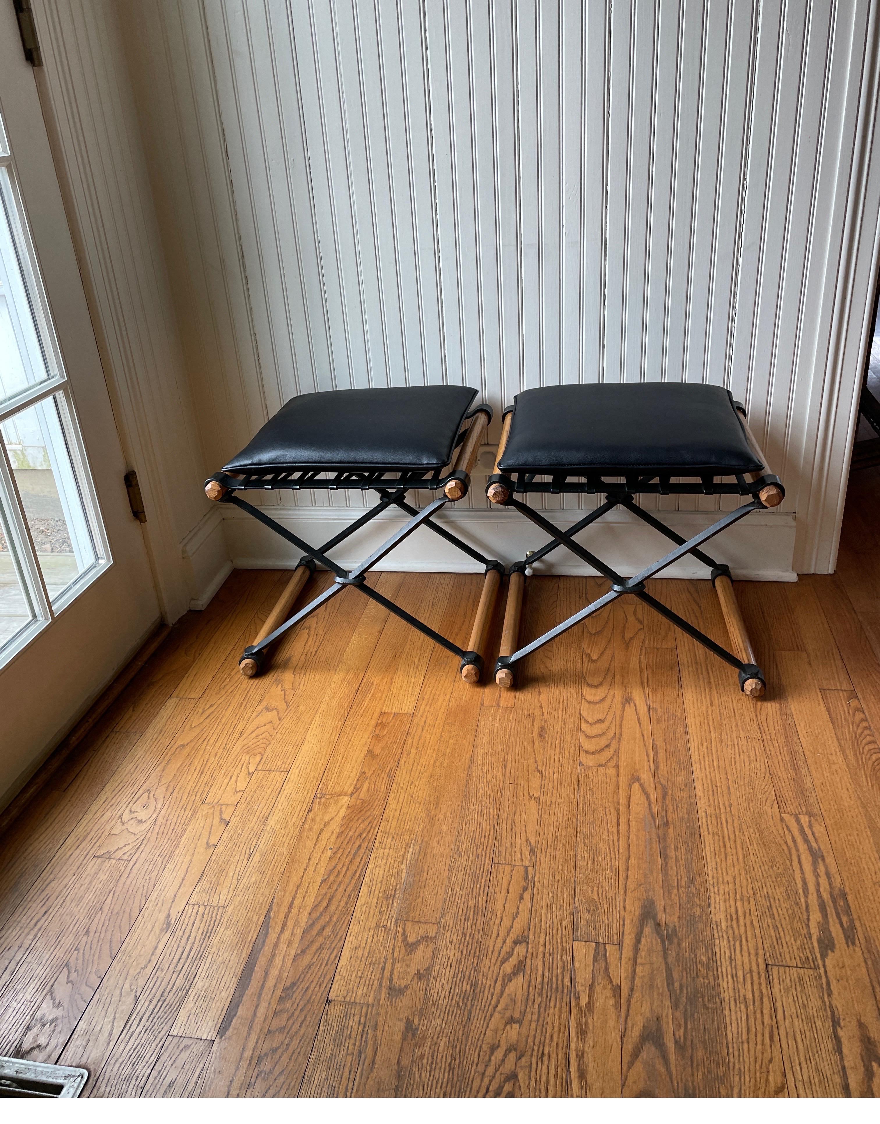 A pair of wrought iron and oak mid century stools by Cleo Baldon. The cushions are newly made of faux leather.