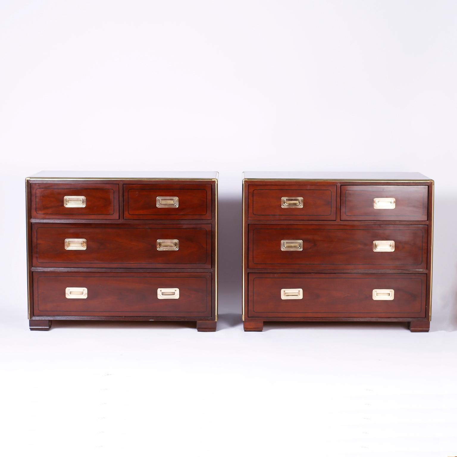 Pair of British Colonial mahogany chests of drawers with brass Campaign hardware, string inlaid borders around the drawer fronts and stylized block feet. Signed Baker in a drawer.