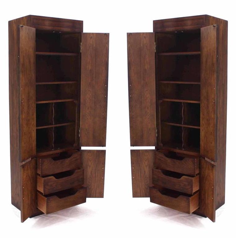 Vintage Campaign style chifforobes or cabinets, made by esteemed American manufacturer, Henredon. Part of Henredon’s early Scene One collection. Each dark-stained, hardwood case fronts fitted with brass hinges and flush latch pulls, over a toe-kick