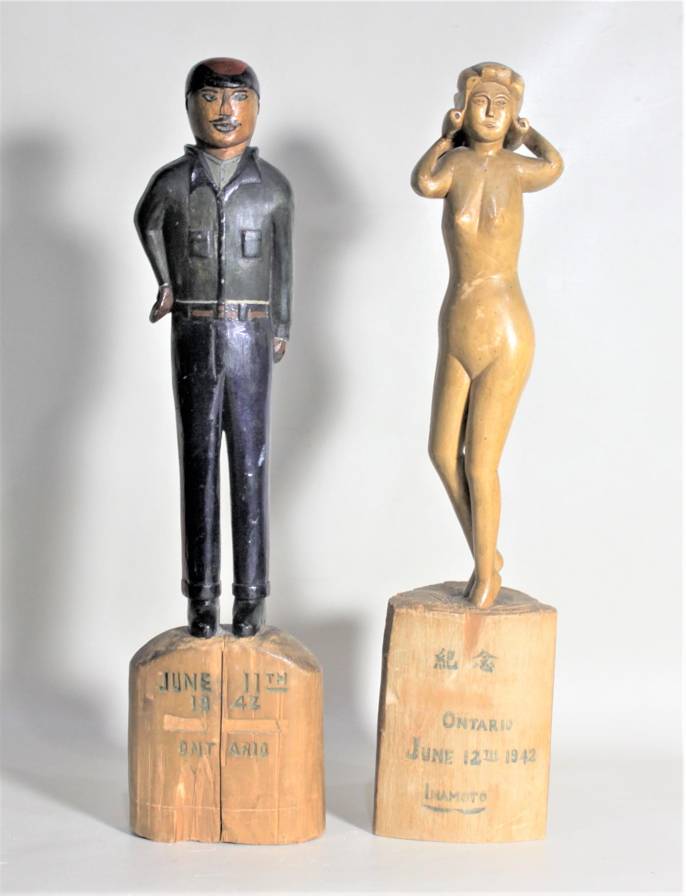 This pair of Folk Art carved figures is believed to have been made by a Japanese immigrant to Canada either while or after being interned by the Canadian government during the Second World War. The male carved figure is hand painted in vibrant