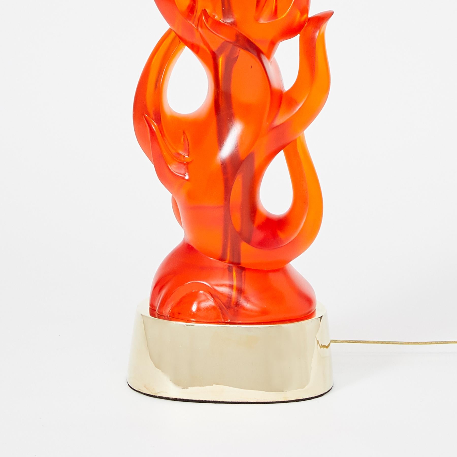 A pair of cast coral tinted transparent resin table lamps in the form of a flame. The oval base having a symmetrical, contemporary design, and flame-shaped elements and open sections.

Other color options available. Priced per pair.
 