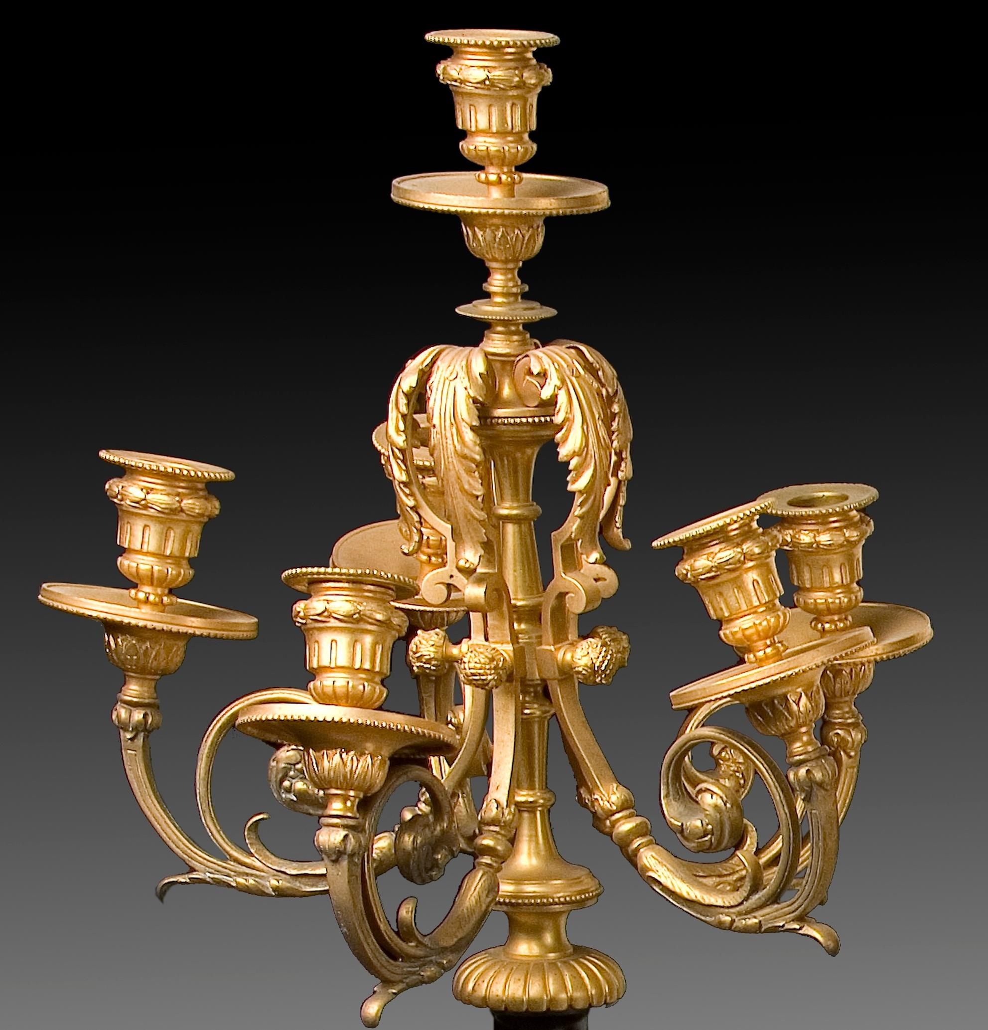 Pair of candleholders. Belgian bronze and marble, 19th century.
Pair of chandeliers with six lights each made in gilt bronze and Belgian marble with a clear classicist inspiration. Both the square stepped pedestal decorated with plant elements and