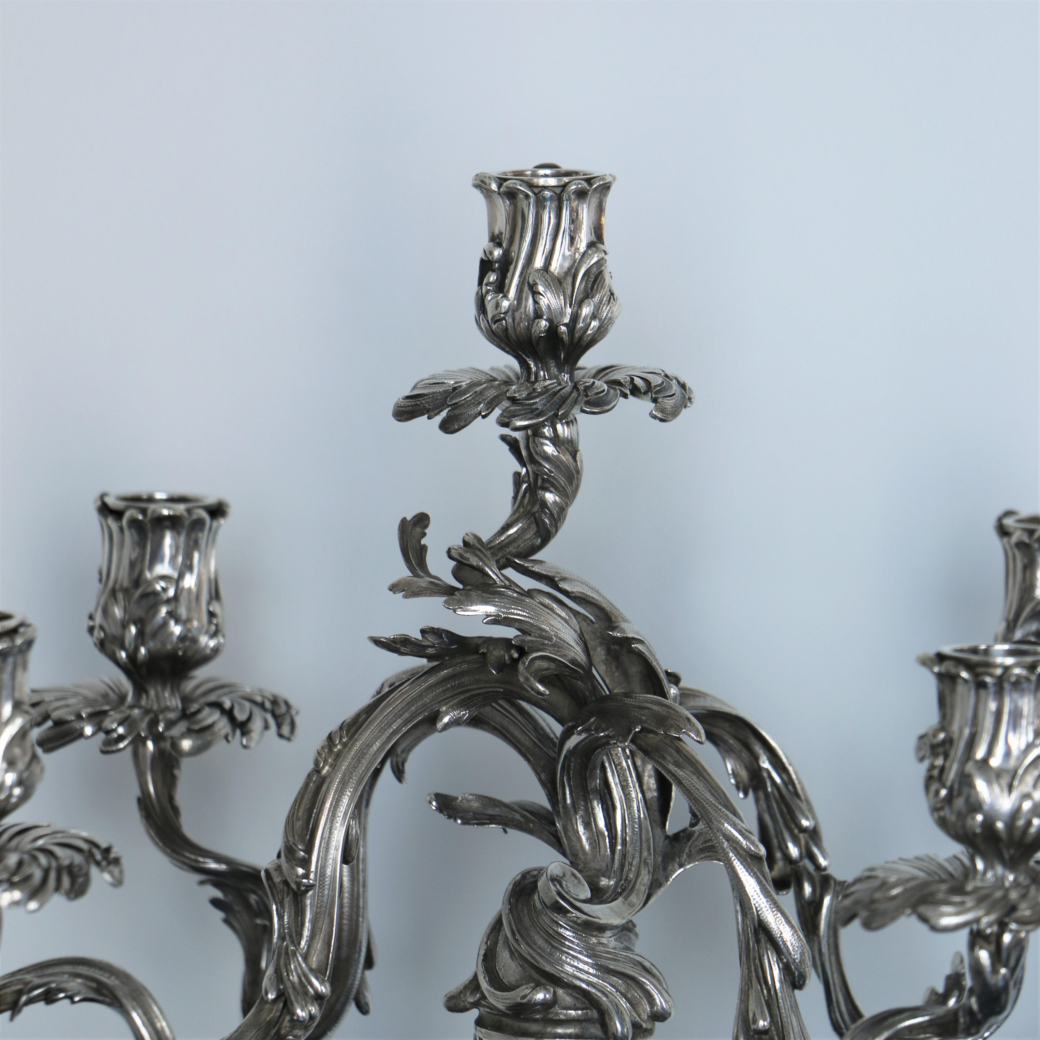 Pair of silver candelabra from Maison Boin-Taburet with 5 lights.

The jeweler Emile Taburet exposed in 1880 at the exhibition of UCAD metal. His punch is crossed out one year later, circa 1880, he partnered with his son, George Boin, antique