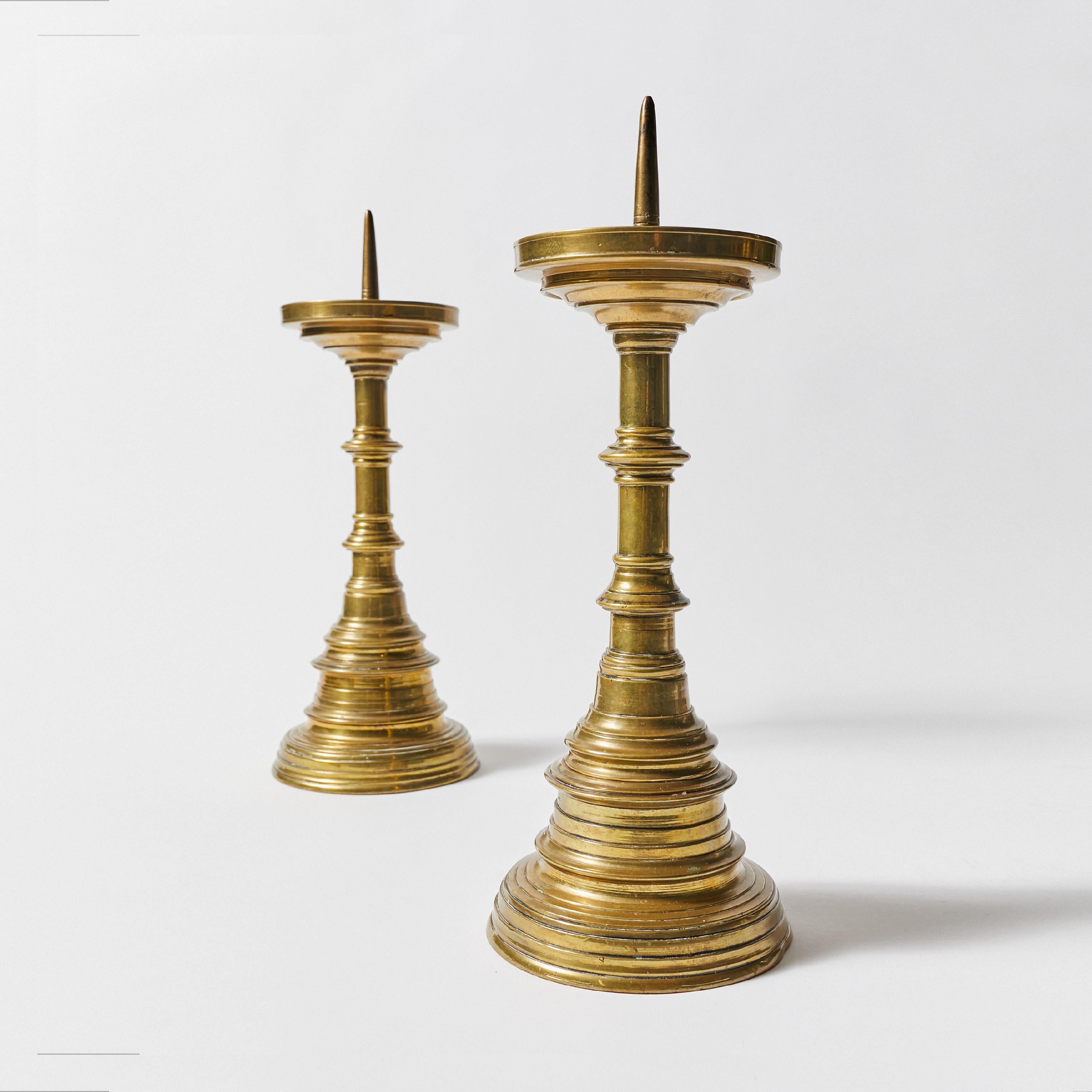 Set of two candle holders in Dutch colonial style. Made in brass with beautiful natural patina.