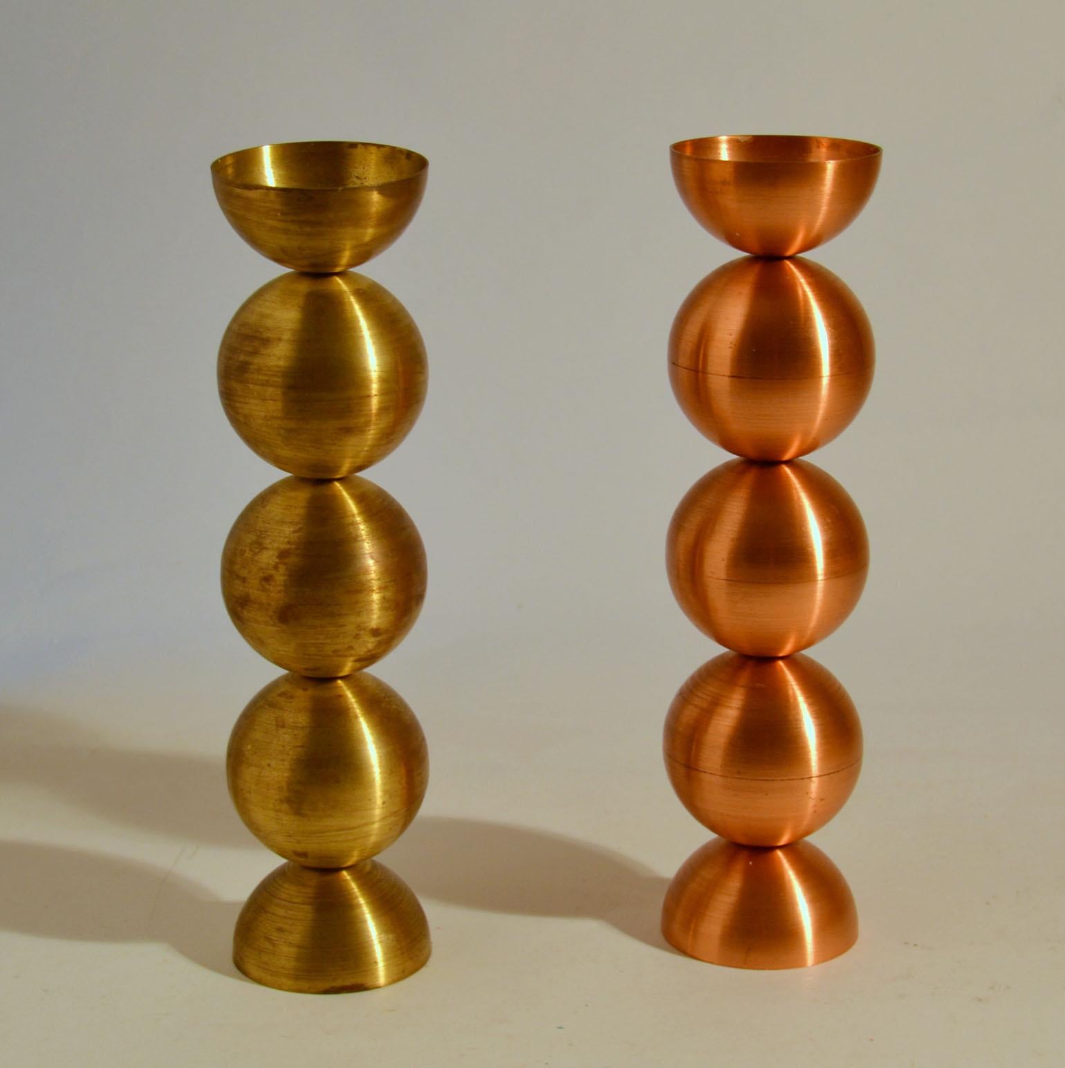 Two candlesticks beaded design. They are spun in spheres from brass and copper. The spinning gives them a nice silky texture and patina.
With candles their height measures 48 cm.