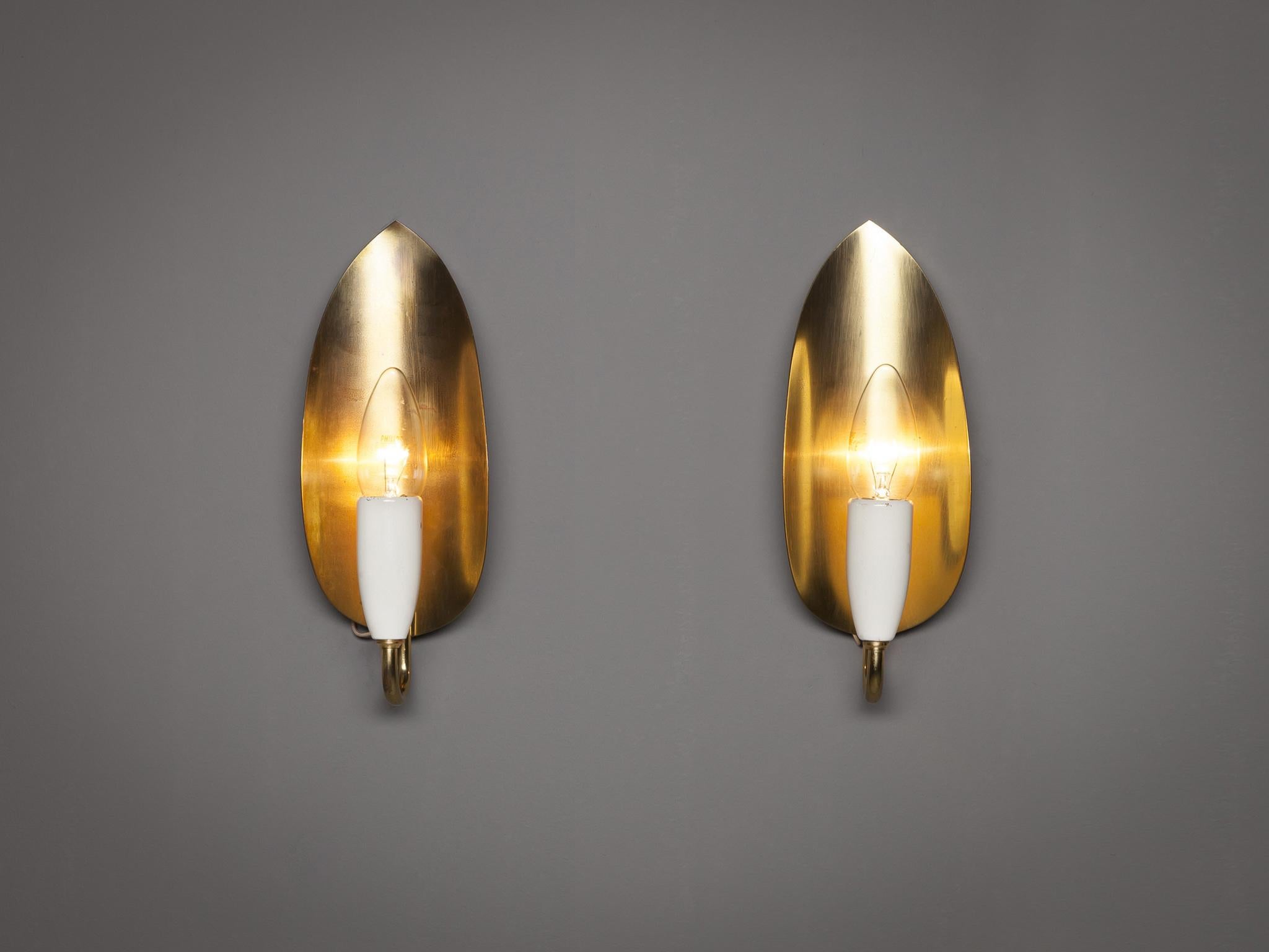 Pair of wall lights, brass, lacquered metal, Europe, 1960s.

A lovely pair of wall lights that resemble a modern candle holder. A curved rod holds the light bulb in place, which is attached to a brass sheet in the shape of an abstract leaf. The