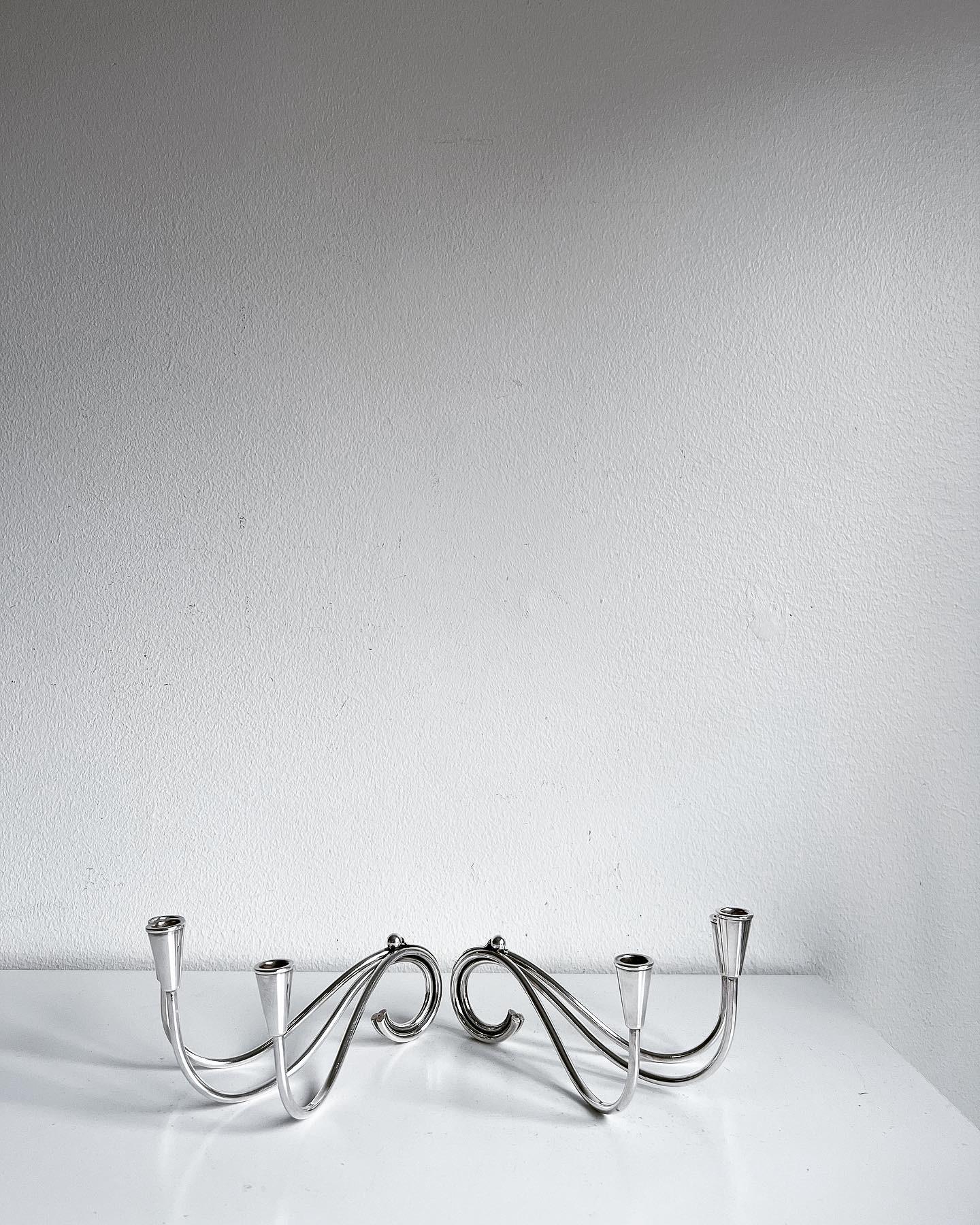 A beautiful pair of Danish Mid-Century Modern silver plated three-arm candleholders by designer Carl Frederik Christiansen, ca 1960-70s, Denmark. Both are marked with designers' initials 
