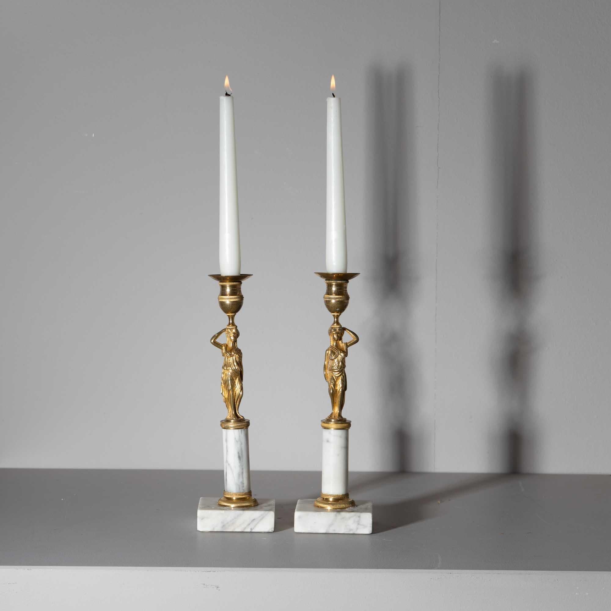 Pair of Empire candlesticks with bronze karyatids and white marble pedestals, 
crafted by Werner & Mieth in Berlin during the early 19th century. 