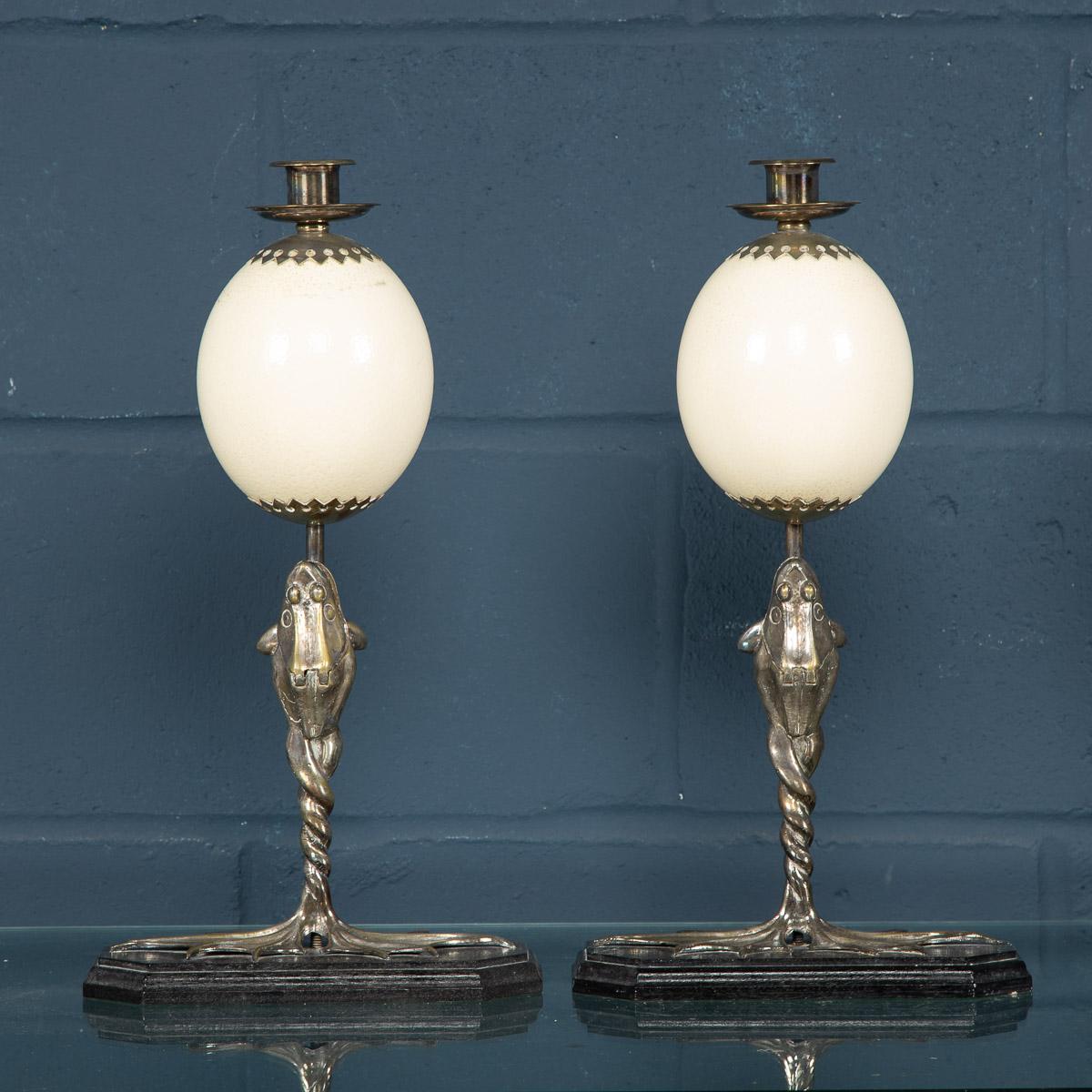 A rare pair of candlesticks by Anthony Redmile. Two ostrich eggs on silver plated mounts fashioned as frogs with mouths that open to reveal a compartment for matches. Anthony Redmile burst into the London interior design scene in the 1960s,
