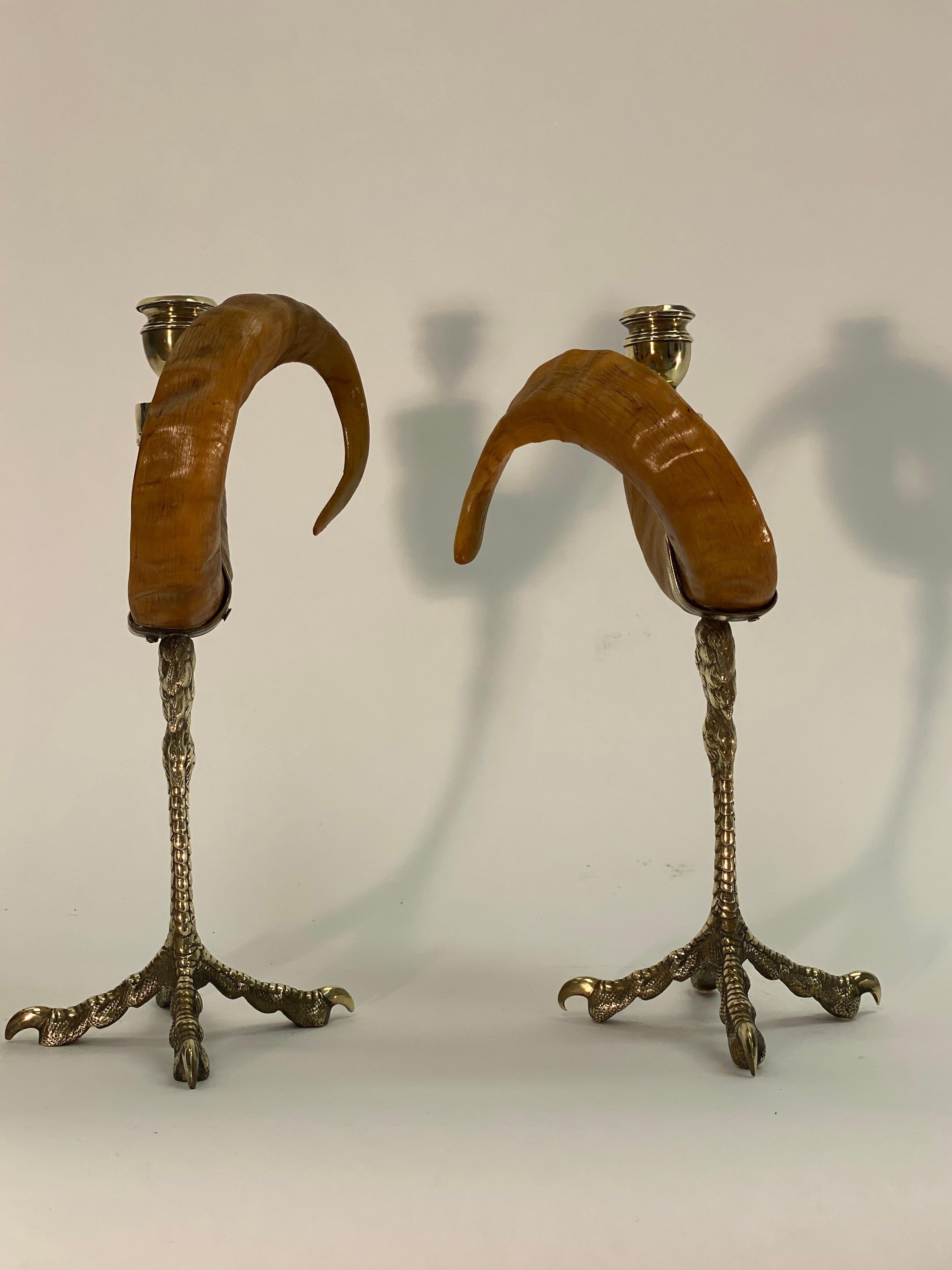 A unique pair of candlesticks by Anthony Redmile. Rams horns mounted to a brass pair of talons. Anthony Redmile gained notoriety in the London interior design scene in the 1960s, producing some of the most eclectic items for his illustrious clients.
