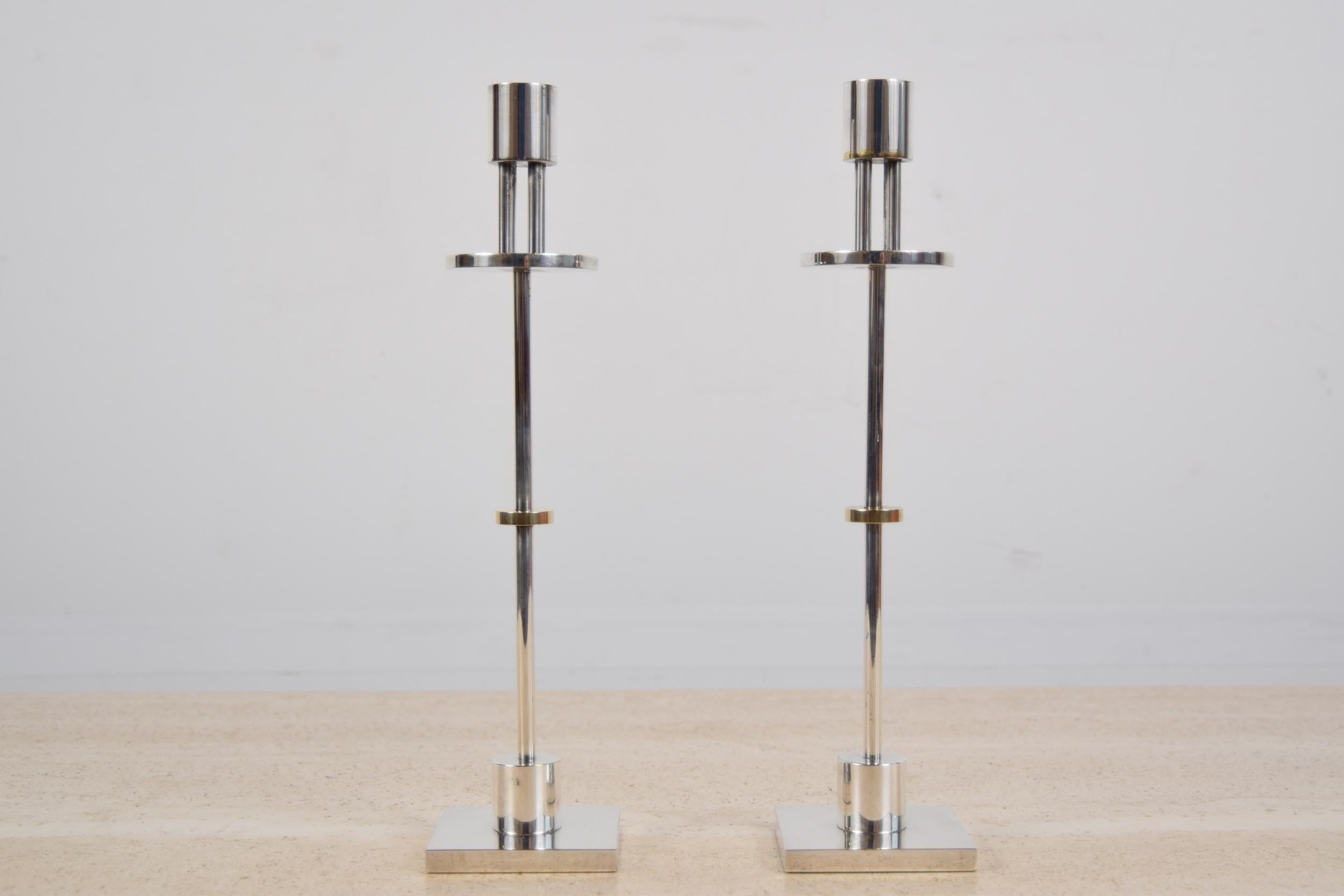 Pair of silver-plated and brass candlesticks designed by Ettore Sottsass for Swid Powell, circa 1988. Candlesticks measure 13