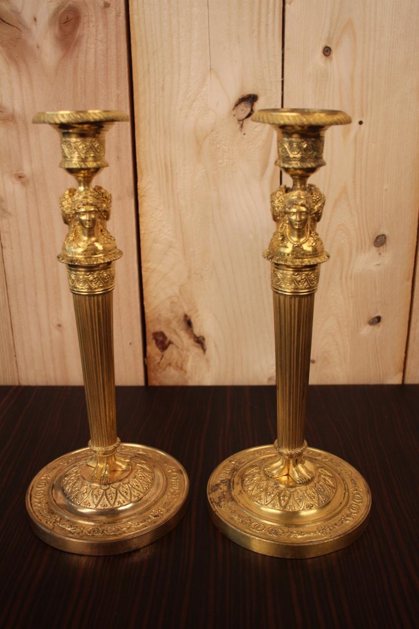 Pair of gilt bronze candlesticks from the Empire period, model of Claude Galle, in their original gilding (some wear of time has been reported) one has been drilled for electricity under a bobèche (can be seen) This model of candlesticks is