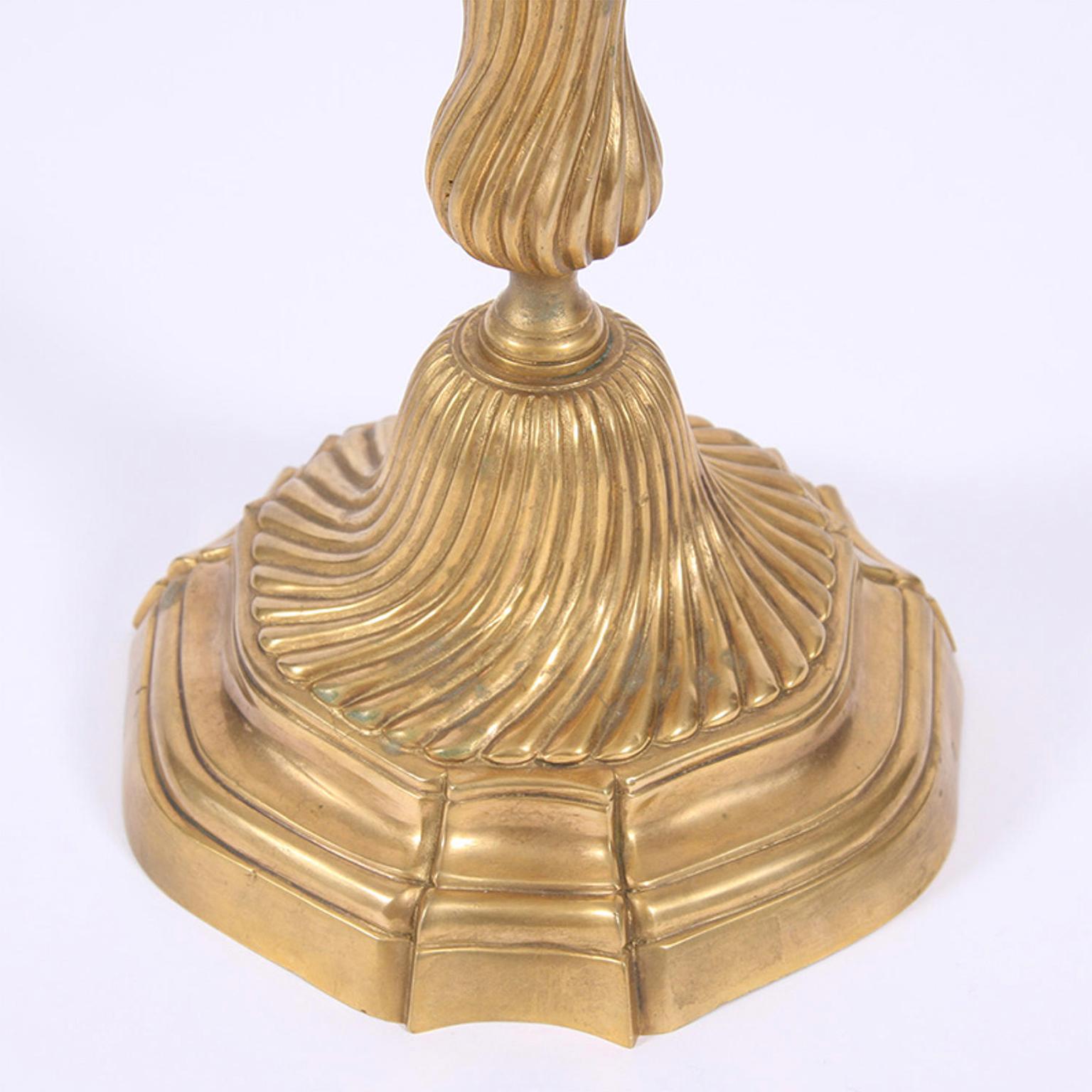 A lovely pair of gilded metal candlesticks with an unusual and very elegant swirl design.