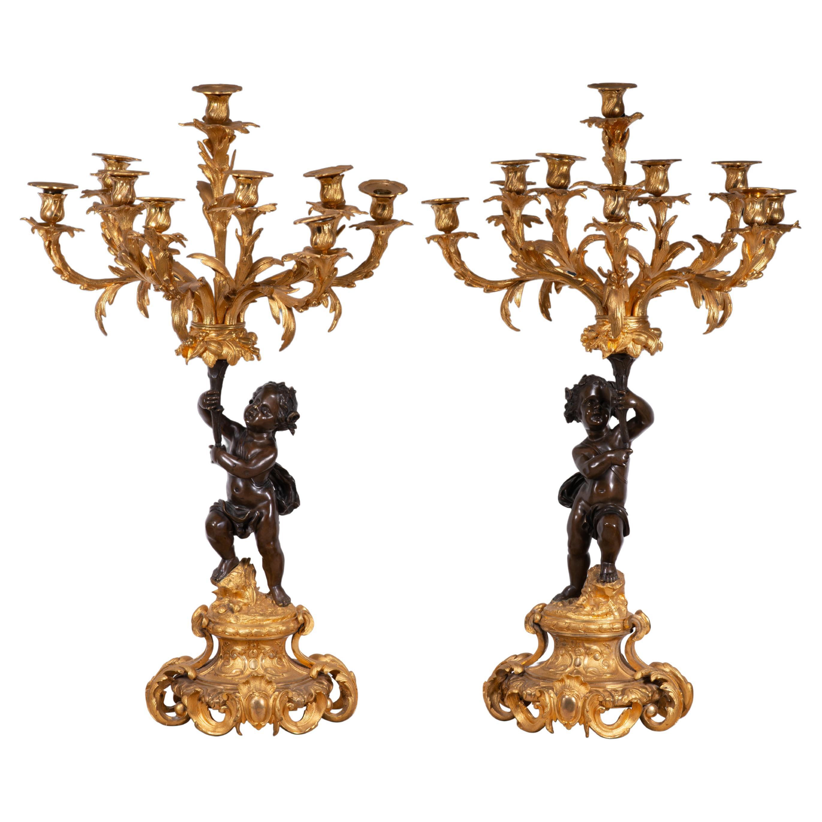 Paire de chandeliers. Bronze doré et bleui. France, 19ème siècle.
