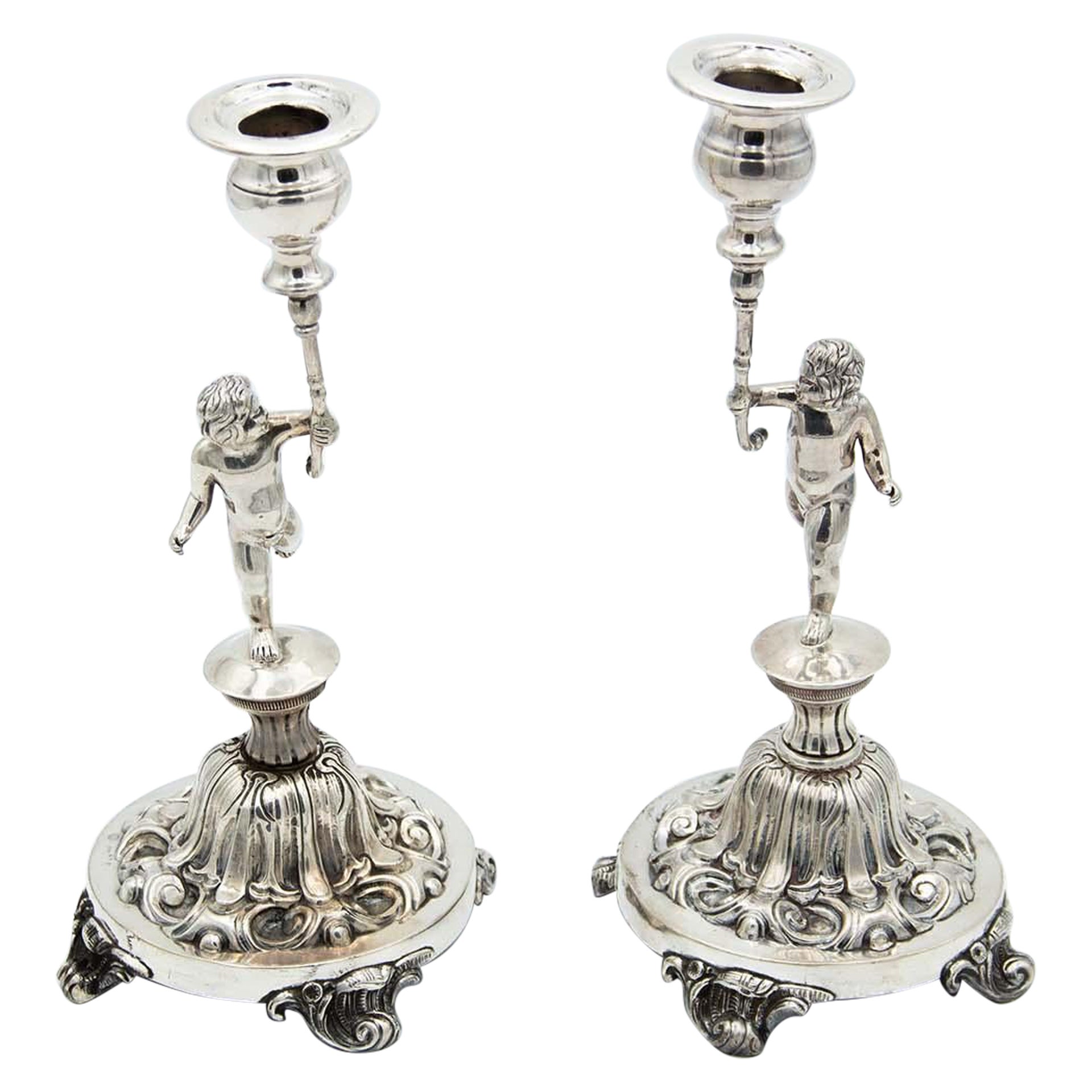 Pair of candlesticks in embossed silver with cherub figures For Sale