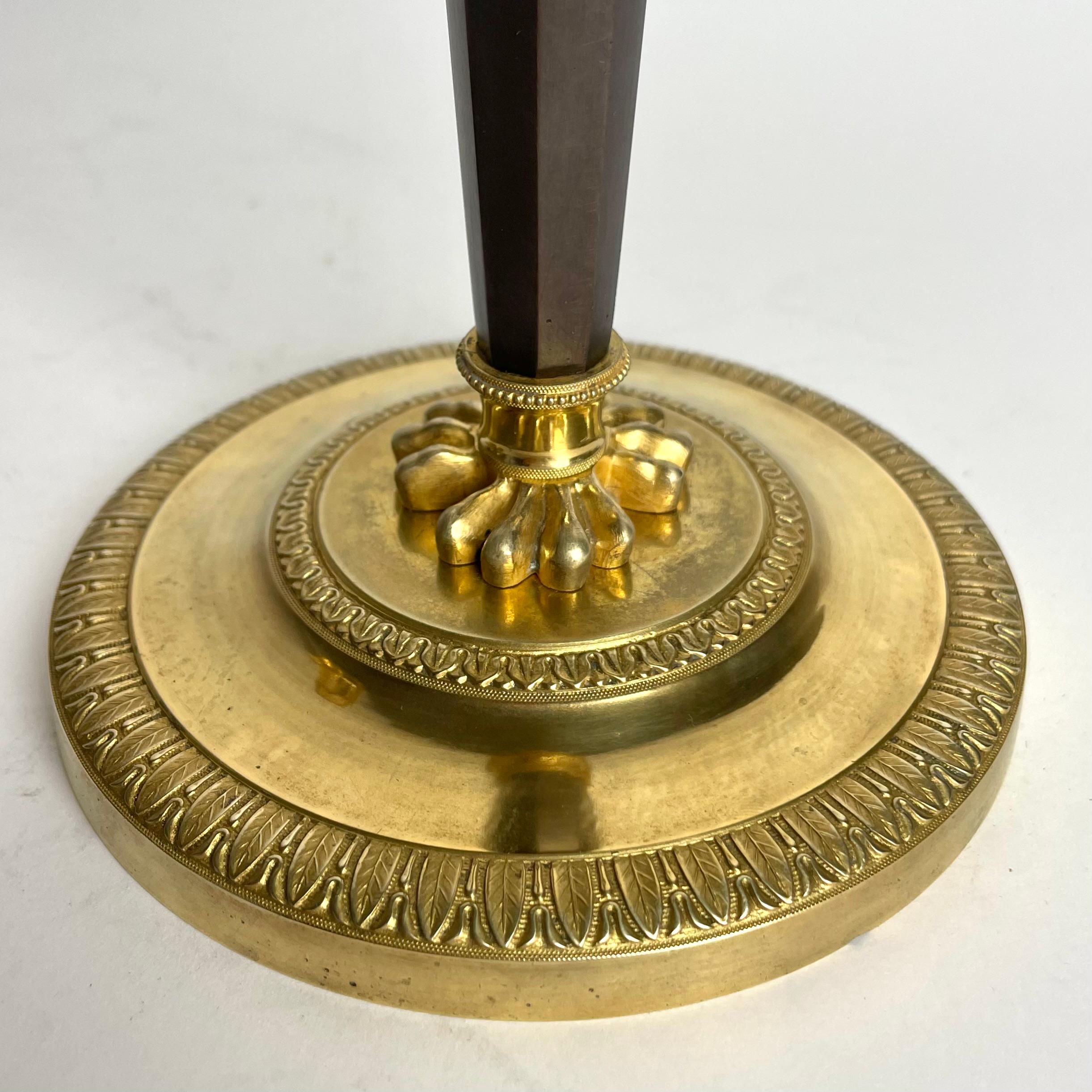 Pair of Candlesticks in gilded and darkpatinated bronze. Directoire circa 1795 For Sale 1