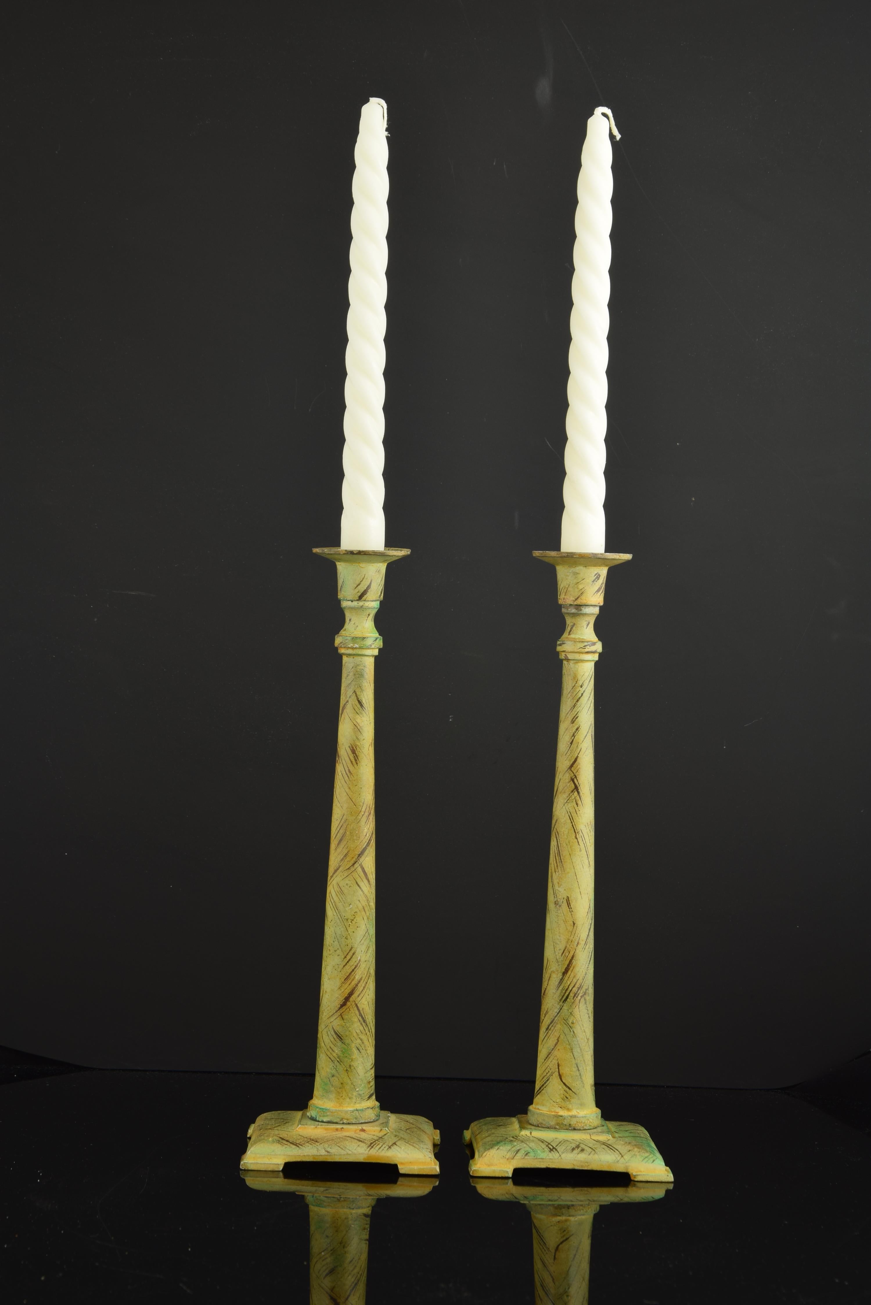 Pair of candlestick in patinated bronze.
The square-shaped base or washer provides stability to the barrel, which has been shaped into a column with a smooth shaft with a notable widening in its lower part. Two concave moldings separate this shaft