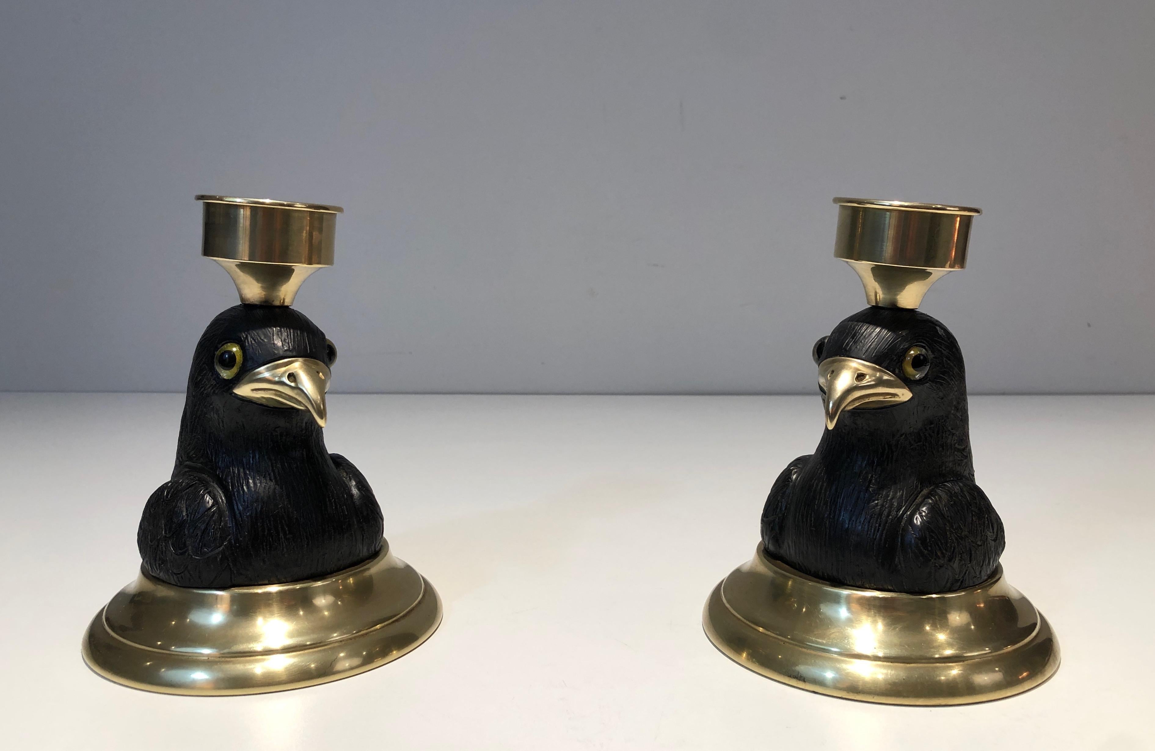 This very nice and rare candlesticks or table lamps are made of carved wood eagles with brass beaks and glass eyes on a brass base. This is a nice French work stamped Houy Pouiga. Circa 1970