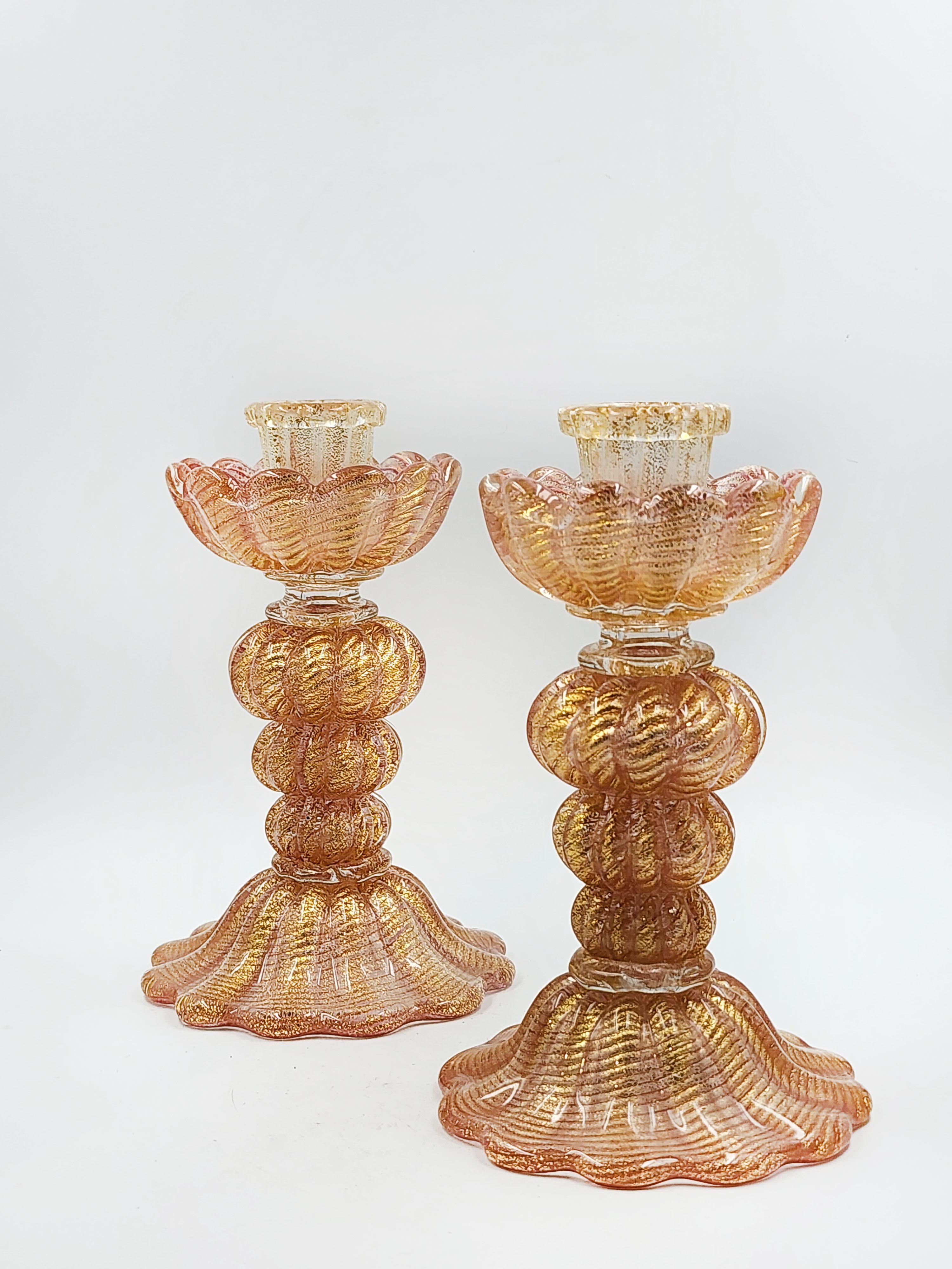 Pair of candlesticks with a design with golden murano glass specks
Beautiful pair of coral murano glass candle holders with gold flecks that make it stand out with a complex and textured design giving an oceanic feel, with wavy folds and intricate