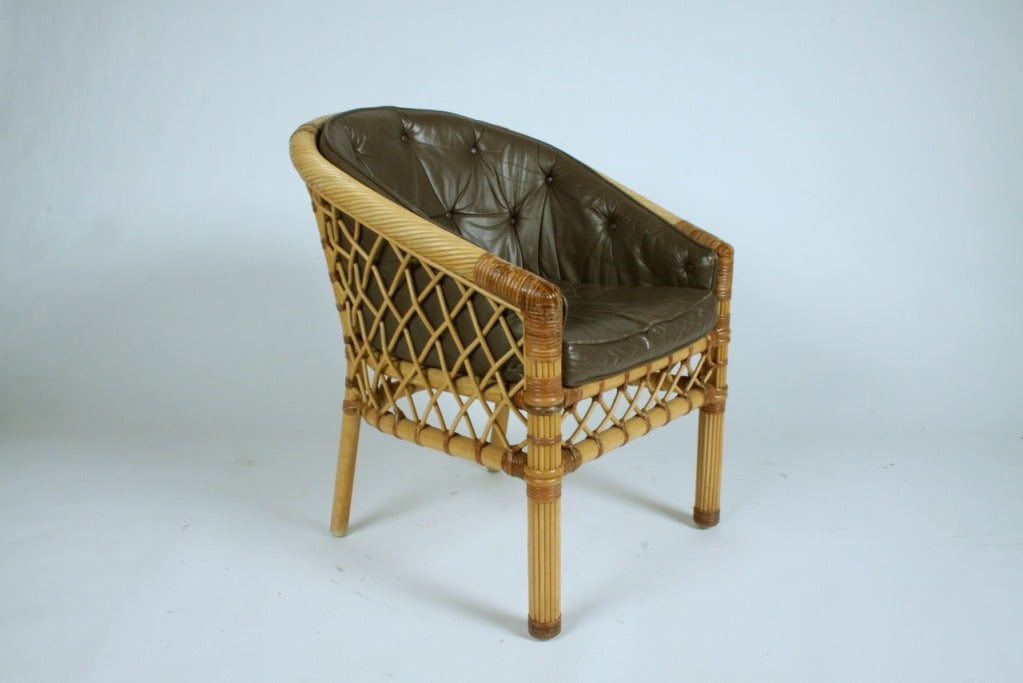 Pair of woven cane / rattan frame chairs model R8174 with leather cushions by Bielecky Brothers New York City. Leather is in as-is condition. Bielecky Brothers rattan, cane and wicker is among the finest quality you can buy.