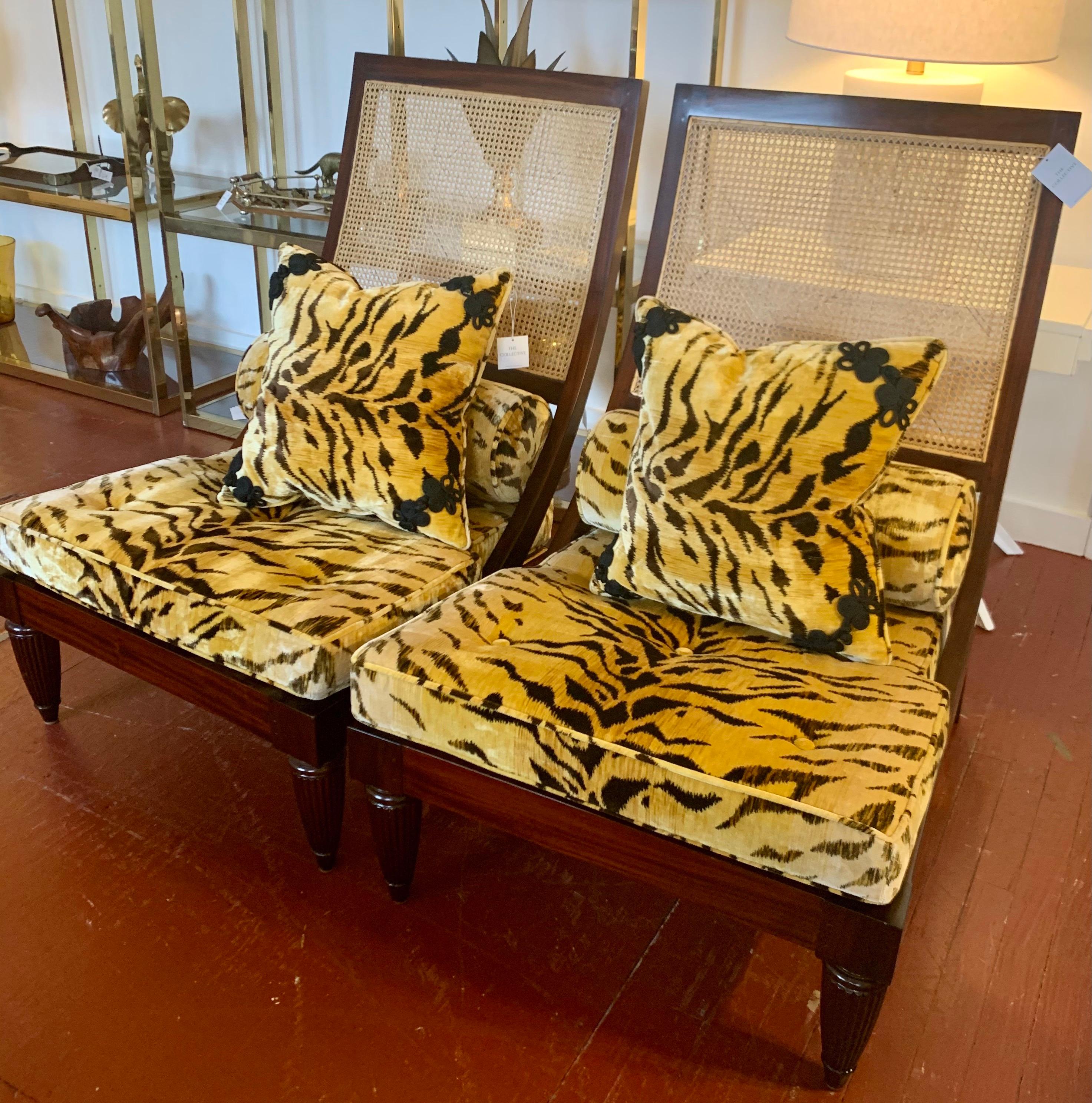 Sleek pair of wood and cane lounge chairs with elegant leopard fabric.