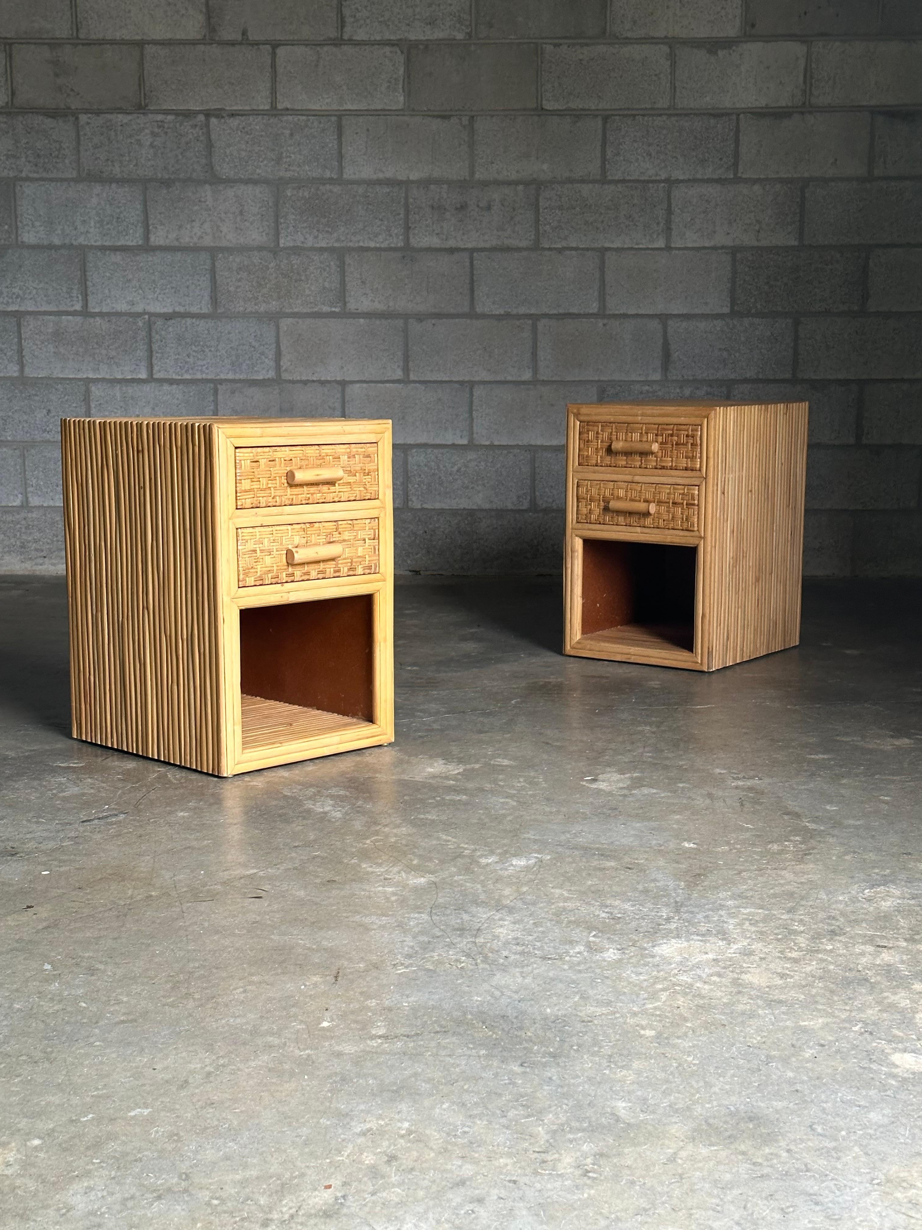 Charming pair of split bamboo and checkered cane drawer front nightstands circa 1980s. Great size with ample drawer space and nice cubby. Could work in a variety of interiors with Ficks Reed, Adrian Pearsall, Milo Baughman, Dunbar, Probber, etc