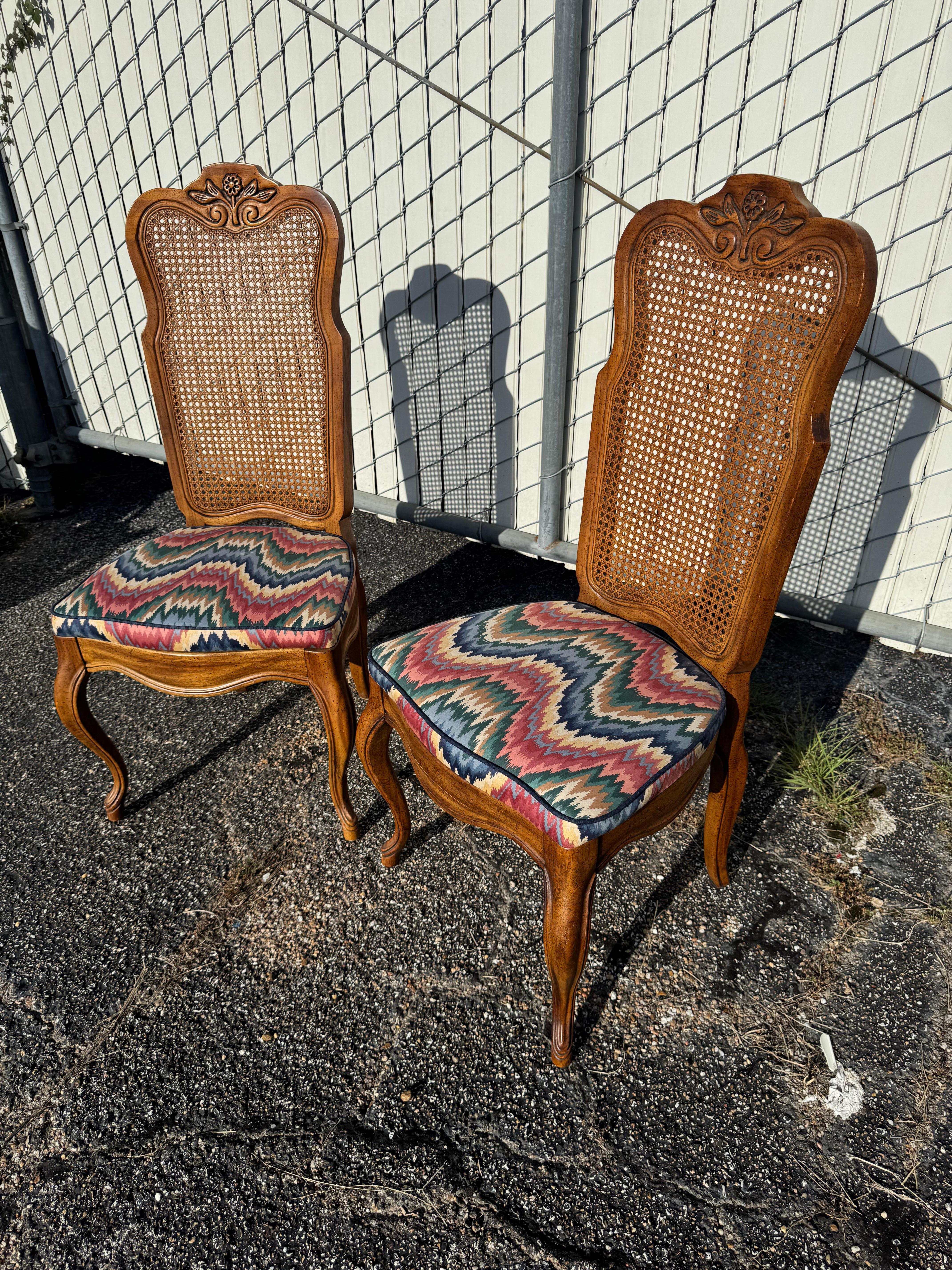 This is a nice pair of  French Provincial cane back side chairs.
The chairs have high backs.
The headrest is carved and the chairs are nicely sculpted.