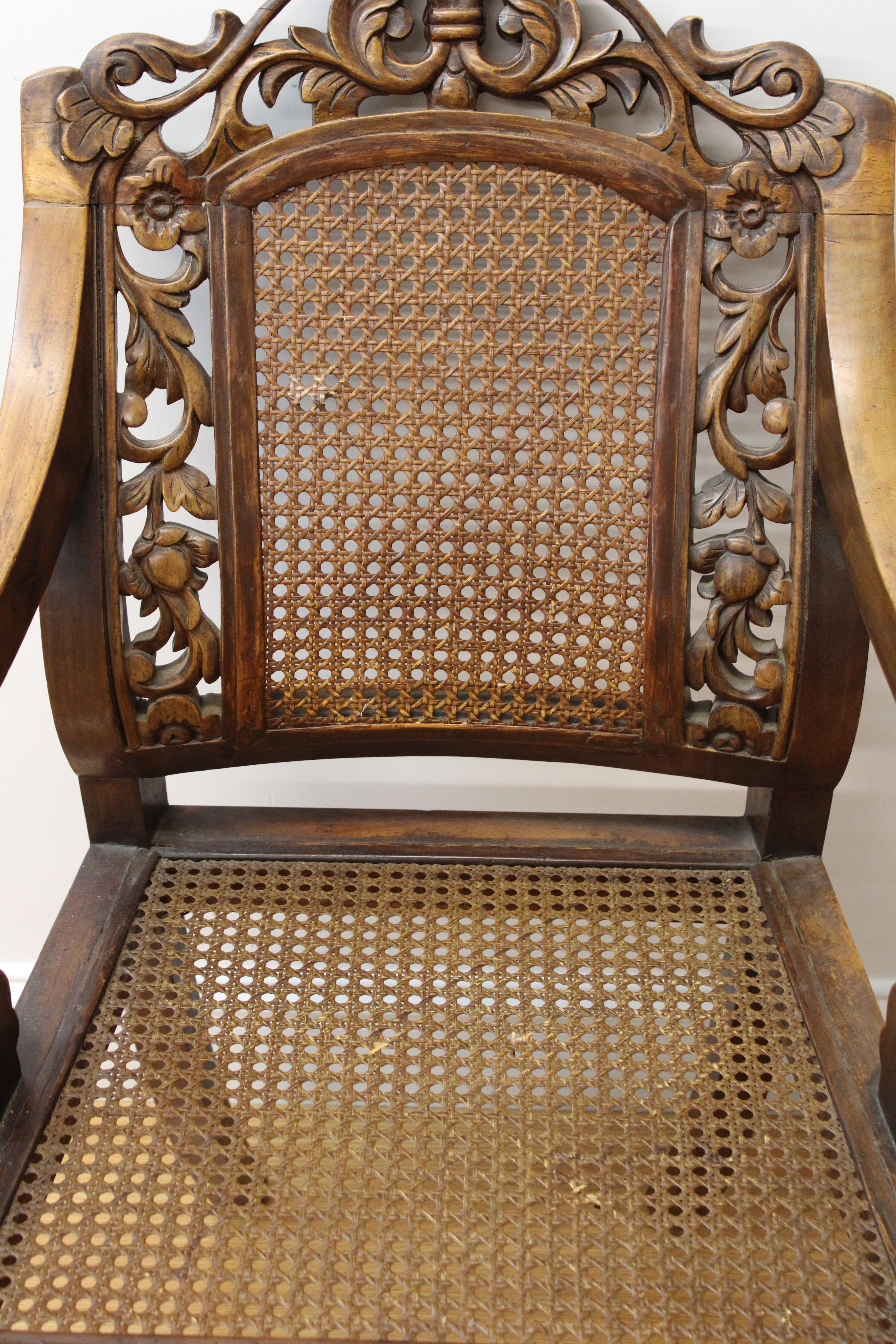 C. 20th century

Pair of caned & carved wood arm chairs, beautifully hand carved floral scroll design on backs.