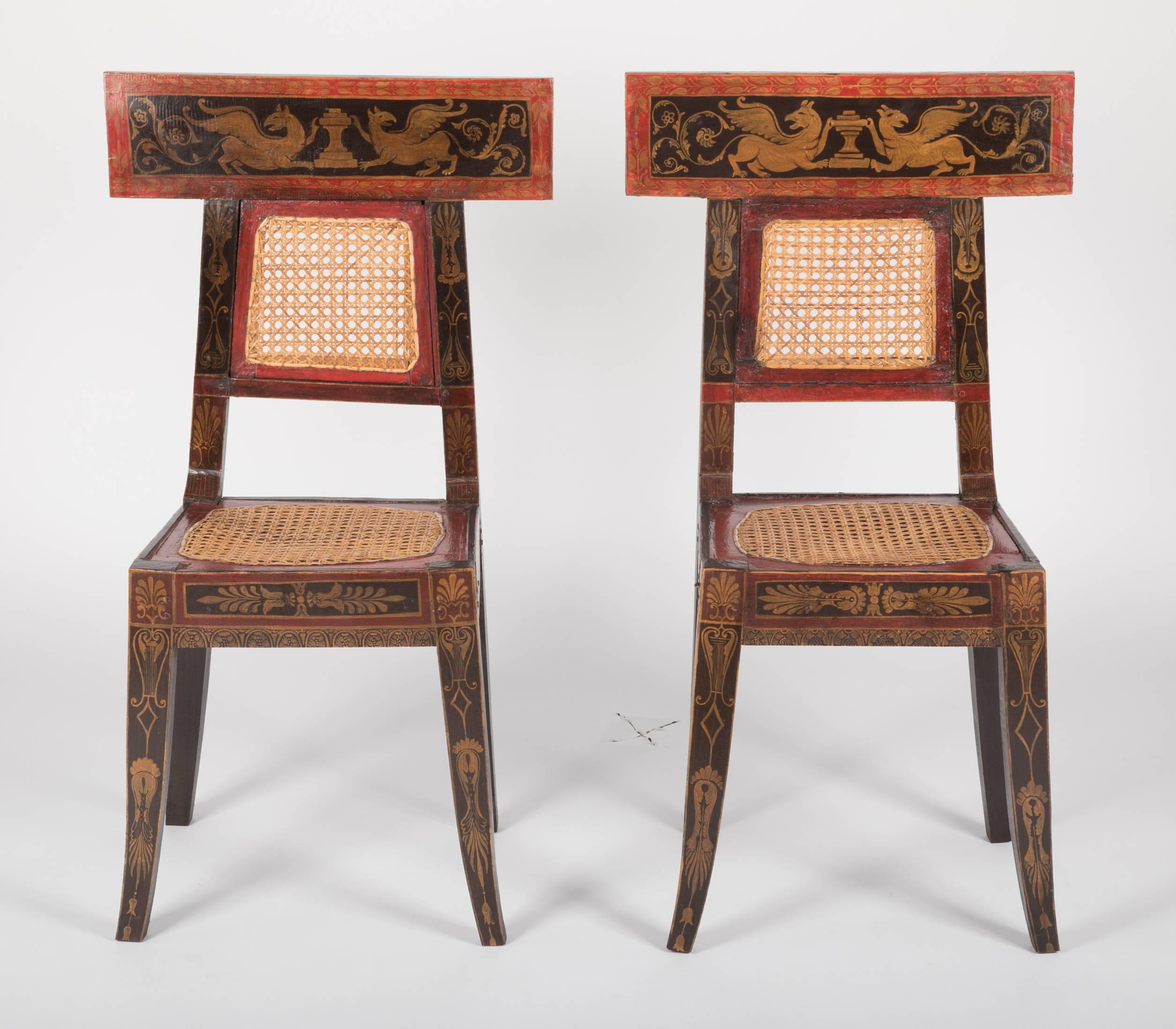 A painted pair of caned hall chairs with Greek key apron, 19th century, possibly Flemish.
Measures: Seat height 19.5.
Seat width 16.75.