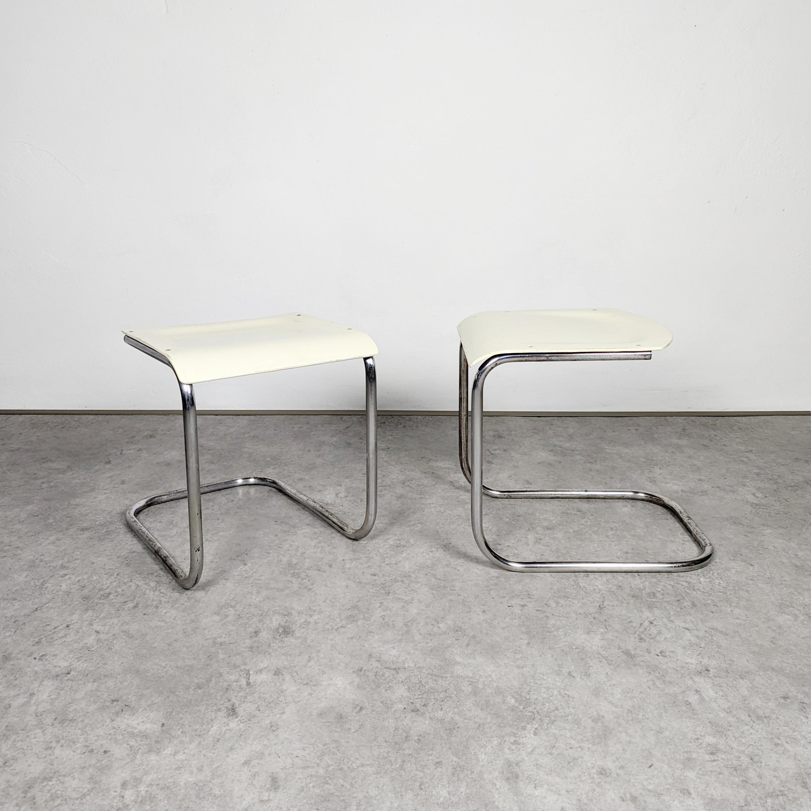 Pair of original cantilever tubular steel hockers designed by Dutch architect Mart Stam in 1920's. This pieces were manufactured under Thonet license by Mücke & Melder company, former Czechoslovakia in early 1930's. Cream white lacquered plywood and