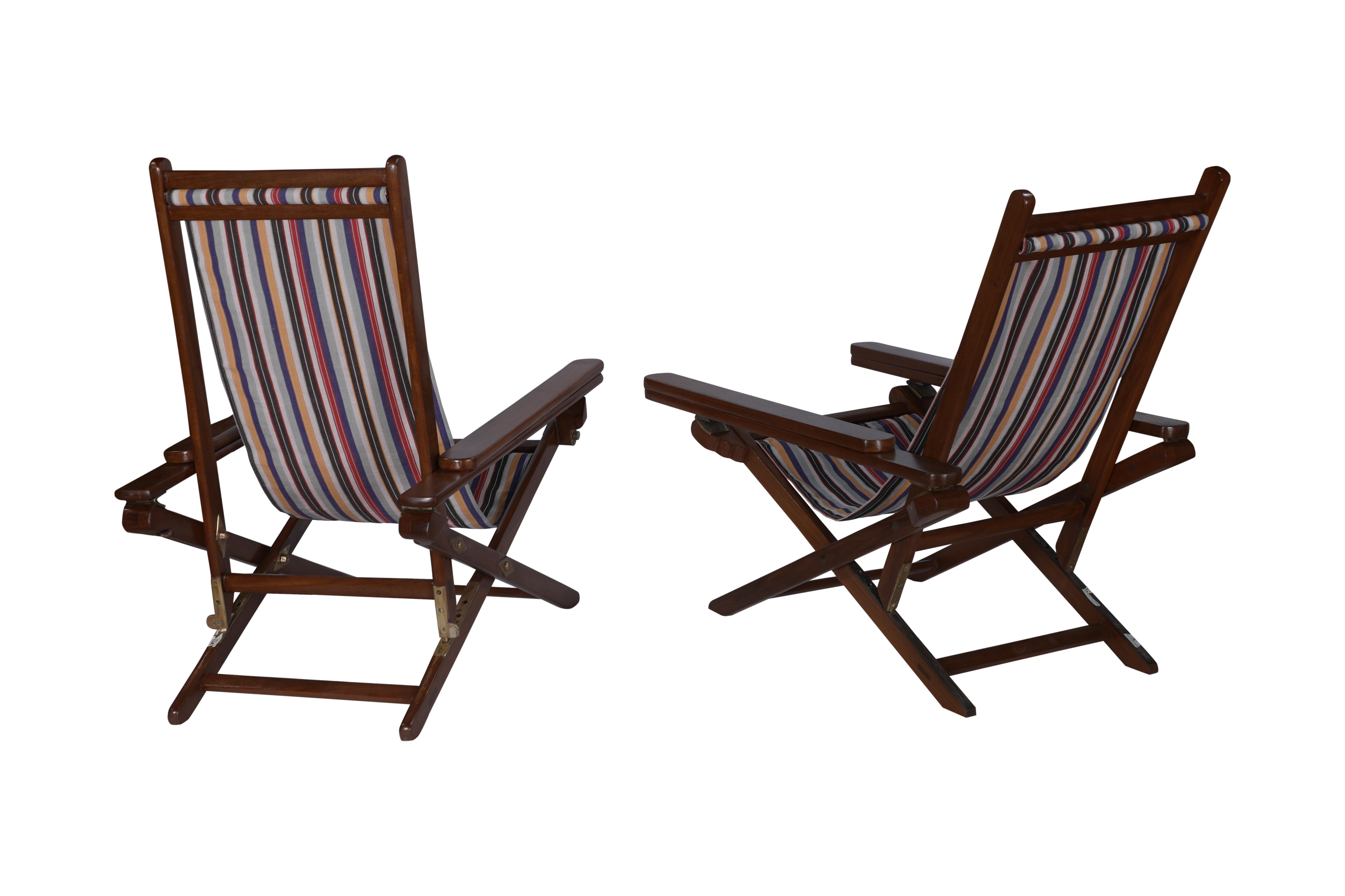 A pair of his and hers Campaign teak folding chairs with canvas sling seats.  The back also adjusts forward and back and the arm rests pull forward creating a leg rest.  There are two canvas options, the stripe and the solid green and both are