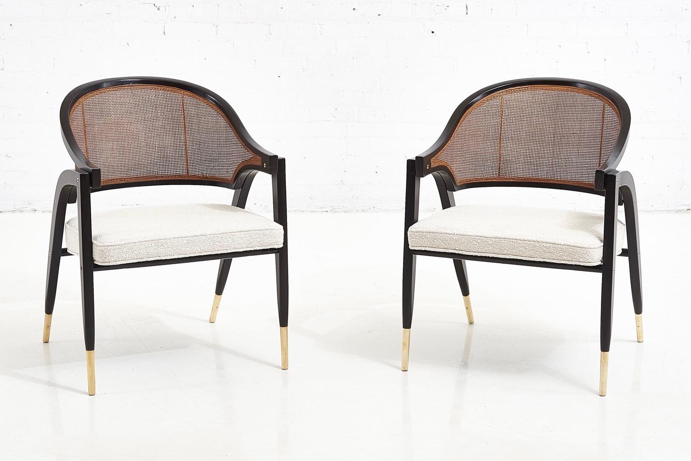 Pair of armchairs designed by Edward Wormley for Dunbar. Sculptural form wood frames with brass details. Cane backs, new boucle upholstered seats.
