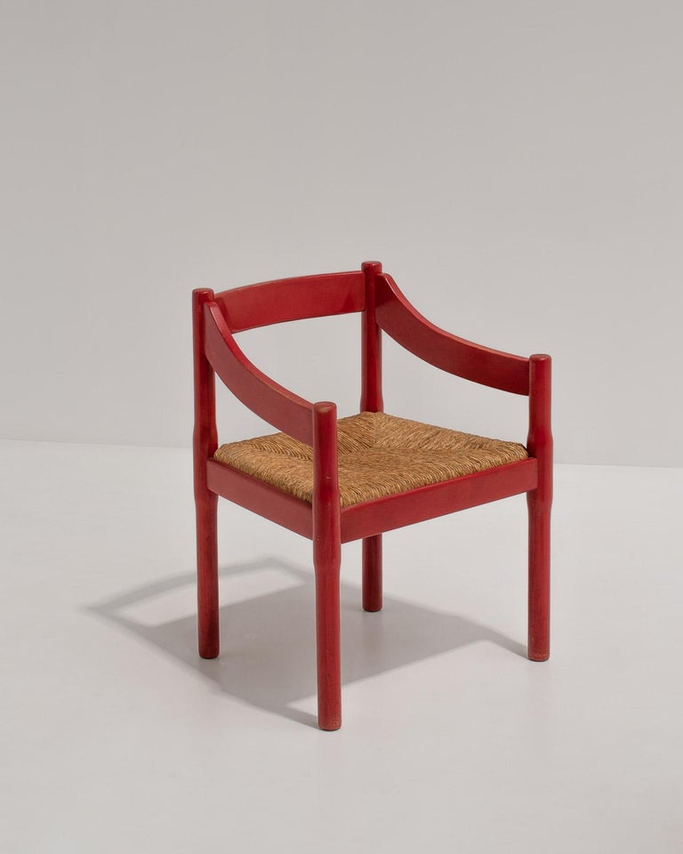 Set of two iconic Cassina Carimate armchairs in red stained beech with rush seat, Italy 1960s

Originally designed in 1959 by renowned Italian designer Vico Magistretti for the Carimate golf club in Lombardy and then produced by Cassina. The
