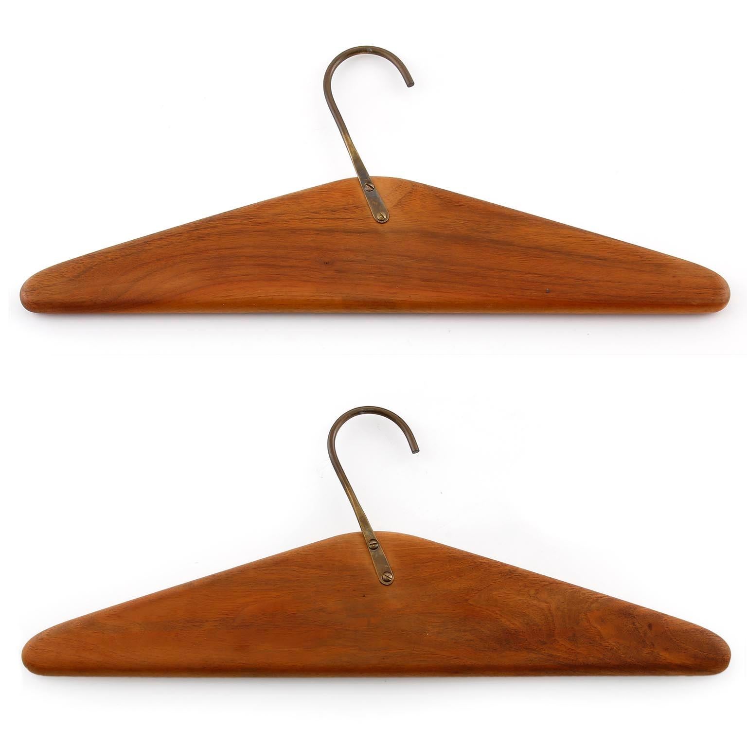 A pair of coat hangers designed by Carl Auböck, manufactured by Carl Auböck workshop in midcentury, Vienna, circa 1960 (late 1950s or early 1960s).
They are made of solid walnut wood and naturally aged brass with lovely patina.
Authentic handmade
