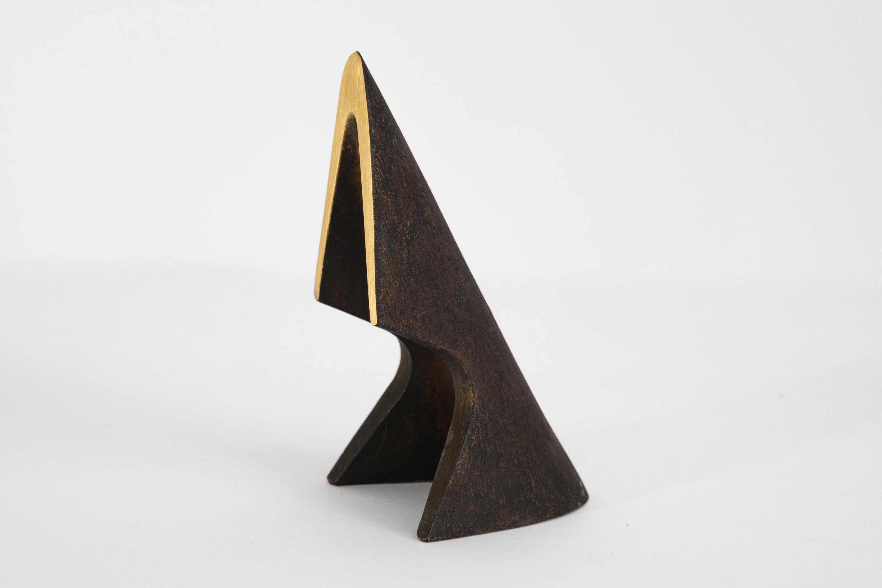 Pair of Carl Auböck Model #4099 patinated brass bookends. Designed in the 1950s, this incredibly refined and sculptural pair of bookends are executed in patinated and polished brass.

Produced by Carl Auböck IV in the original Auböck Werkstätte in