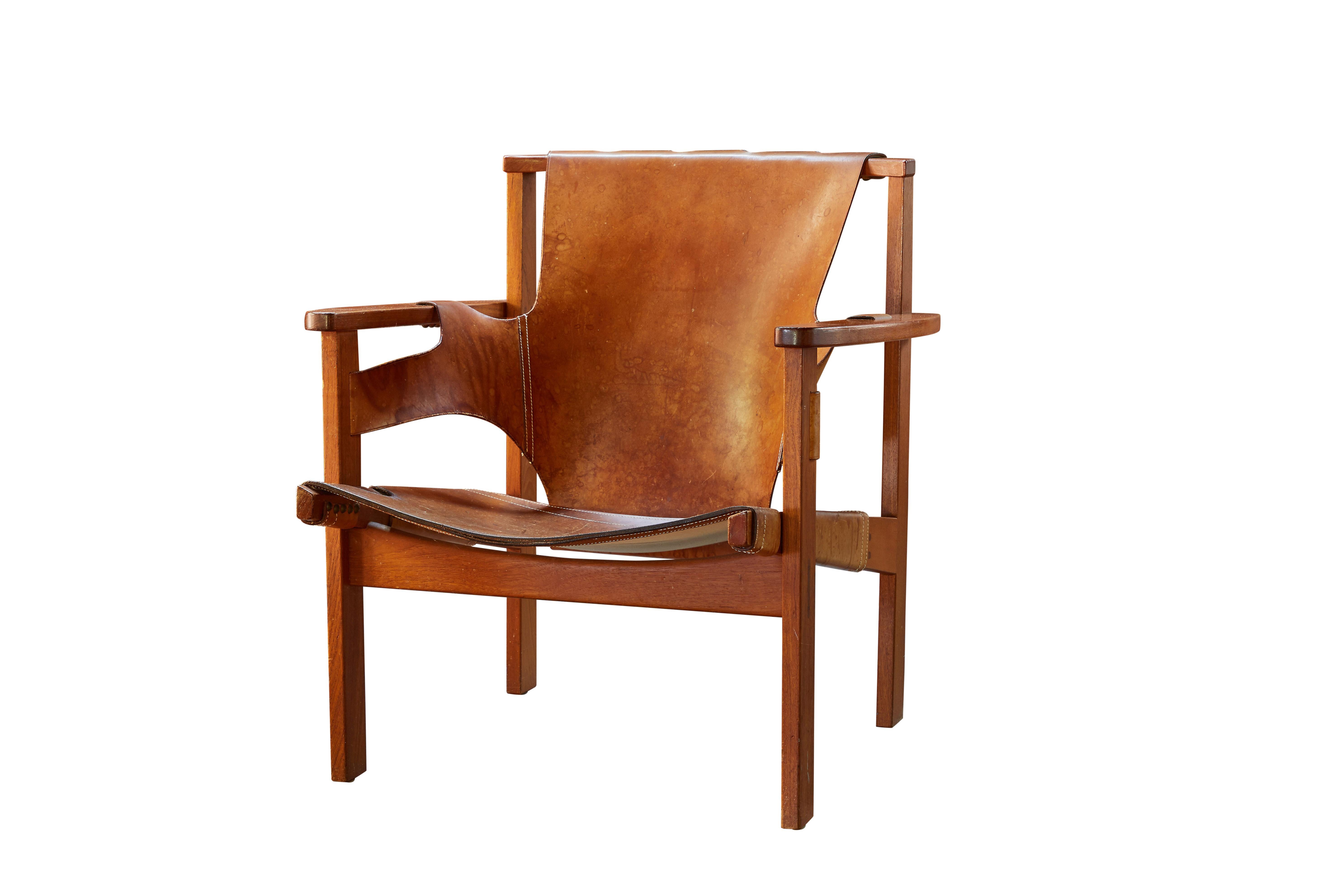 Pair of Carl Axel Acking 'Trienna' chairs in patinated brown leather, circa 1957. Executed in perfectly patinated cognac brown leather and richly grained solid oak for Nordiska Kompaniet. A quintessentially Scandinavian Modern chair by a master