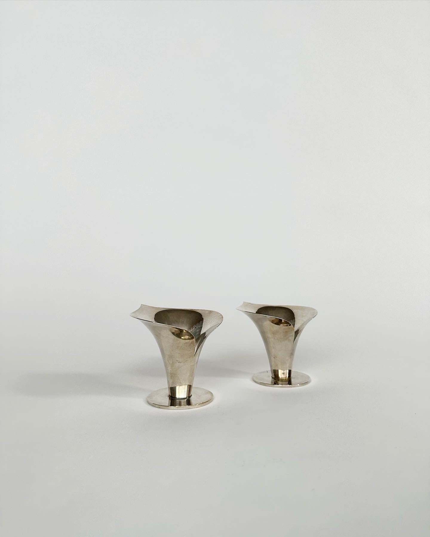 Rare pair of Carl Einar Borgström Calla Lily candle holders in nickel silver plated brass, made by Ystad-Metall in Sweden in the 1940s. 

These were designed for the 1939 New York world fair. 
Both are stamped with the makers mark and the artists