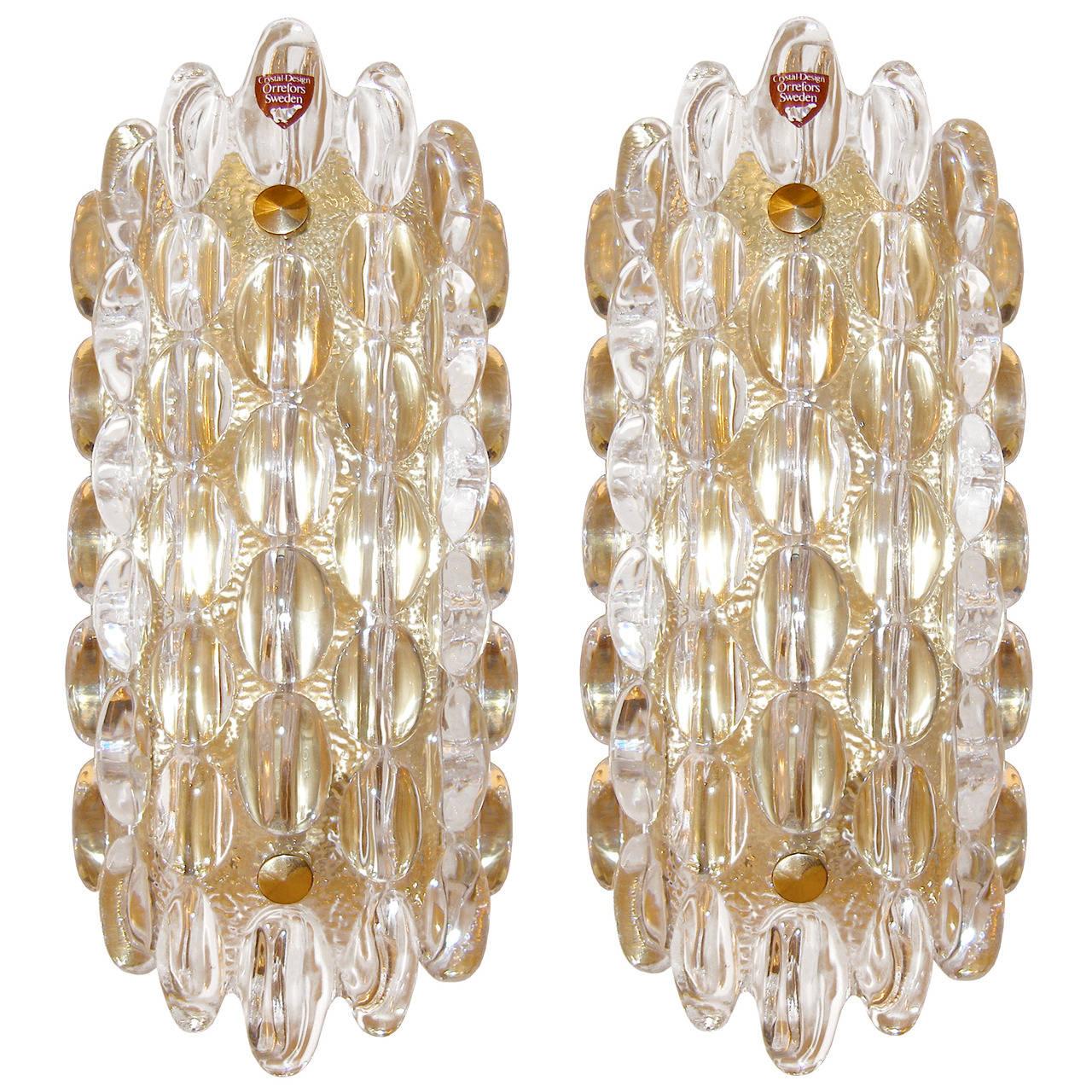 A pair of glass sconces with large glass bubbles mounted on a brass frame by Carl Fagerlund for Orrefors.

Swedish, Circa 1950's