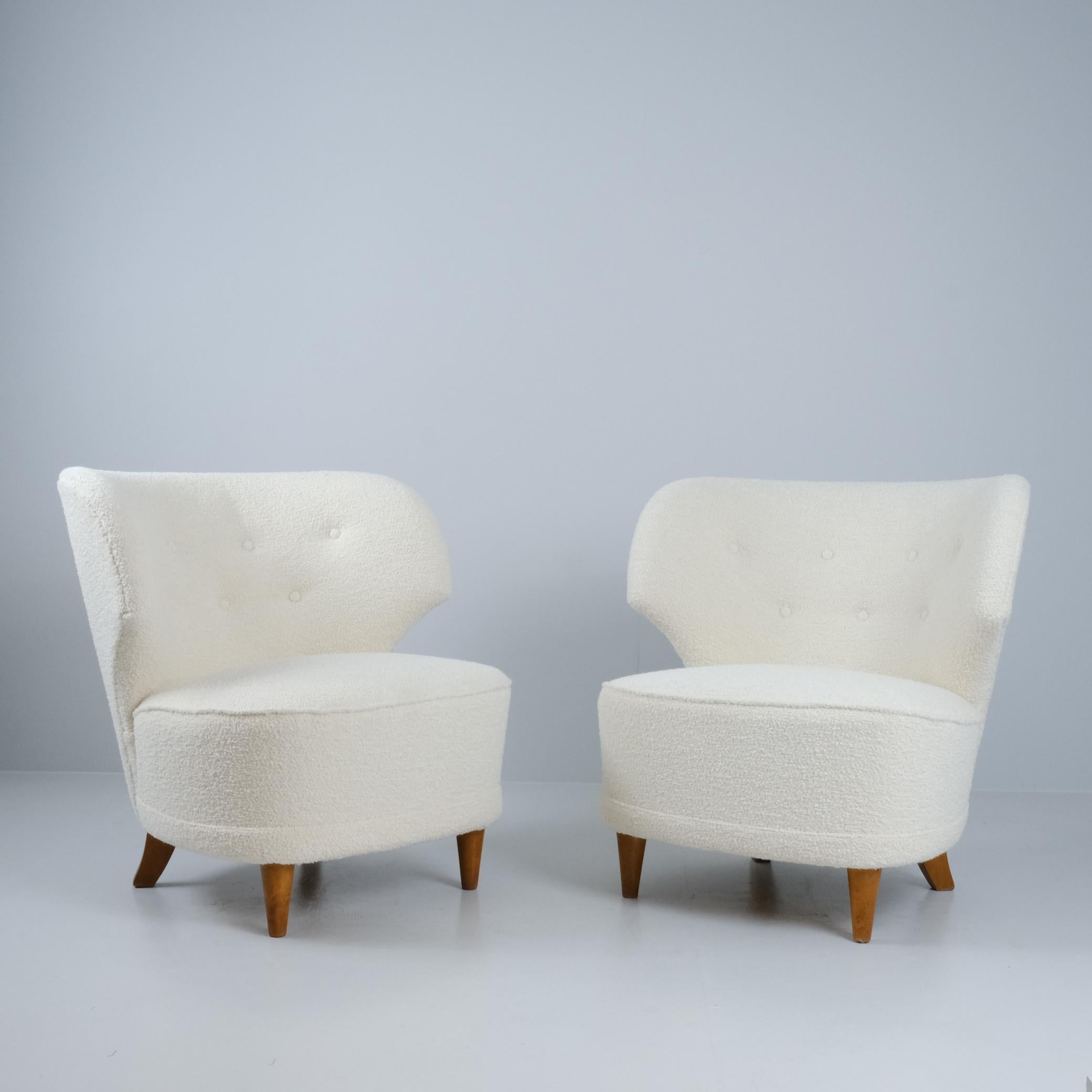 A pair of elegant armchairs designed by Carl-Johan Boman and manufactured by Boman Oy in Finland in the 1950s. Apart from the reupholstery the chair bodies are in original and good condition. 

The chairs are compact in size compared to other