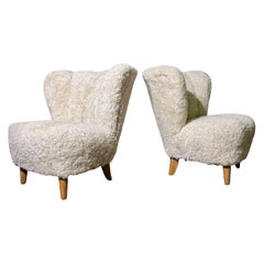 Pareja de sillones Carl-Johan Boman de piel de oveja y madera, Finlandia, 1935